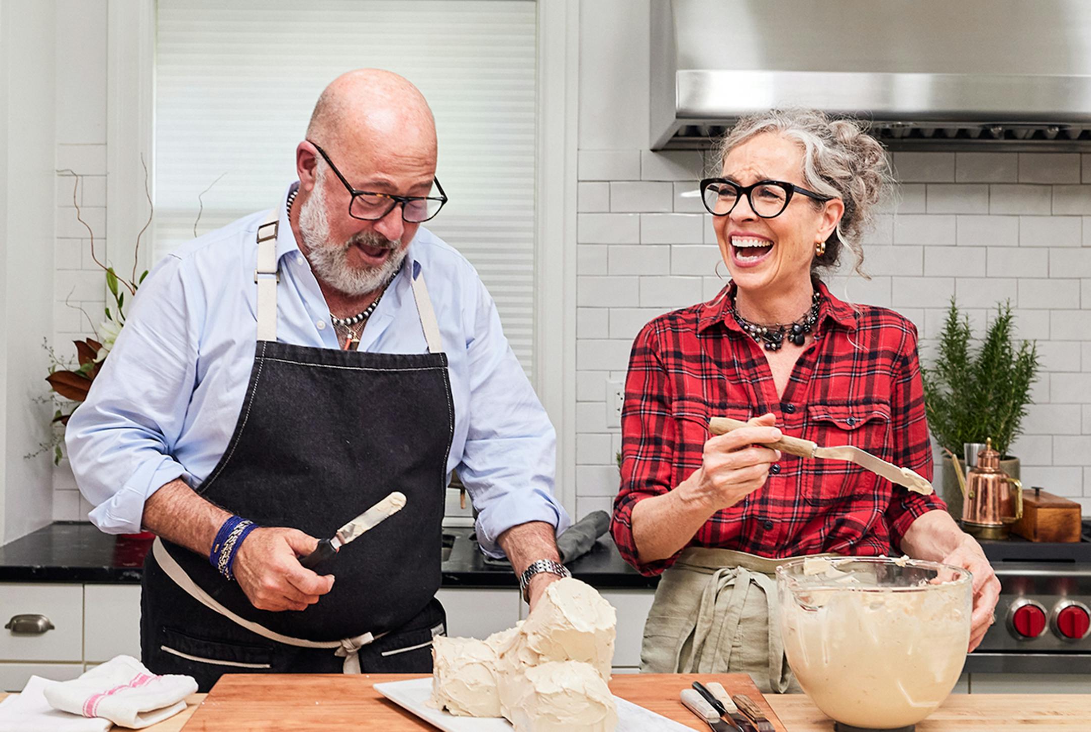 Hosts Zoe Francois and Andrew Zimmern preparing Buche De Noel as seen On Andrew &amp; Zoe holiday special.