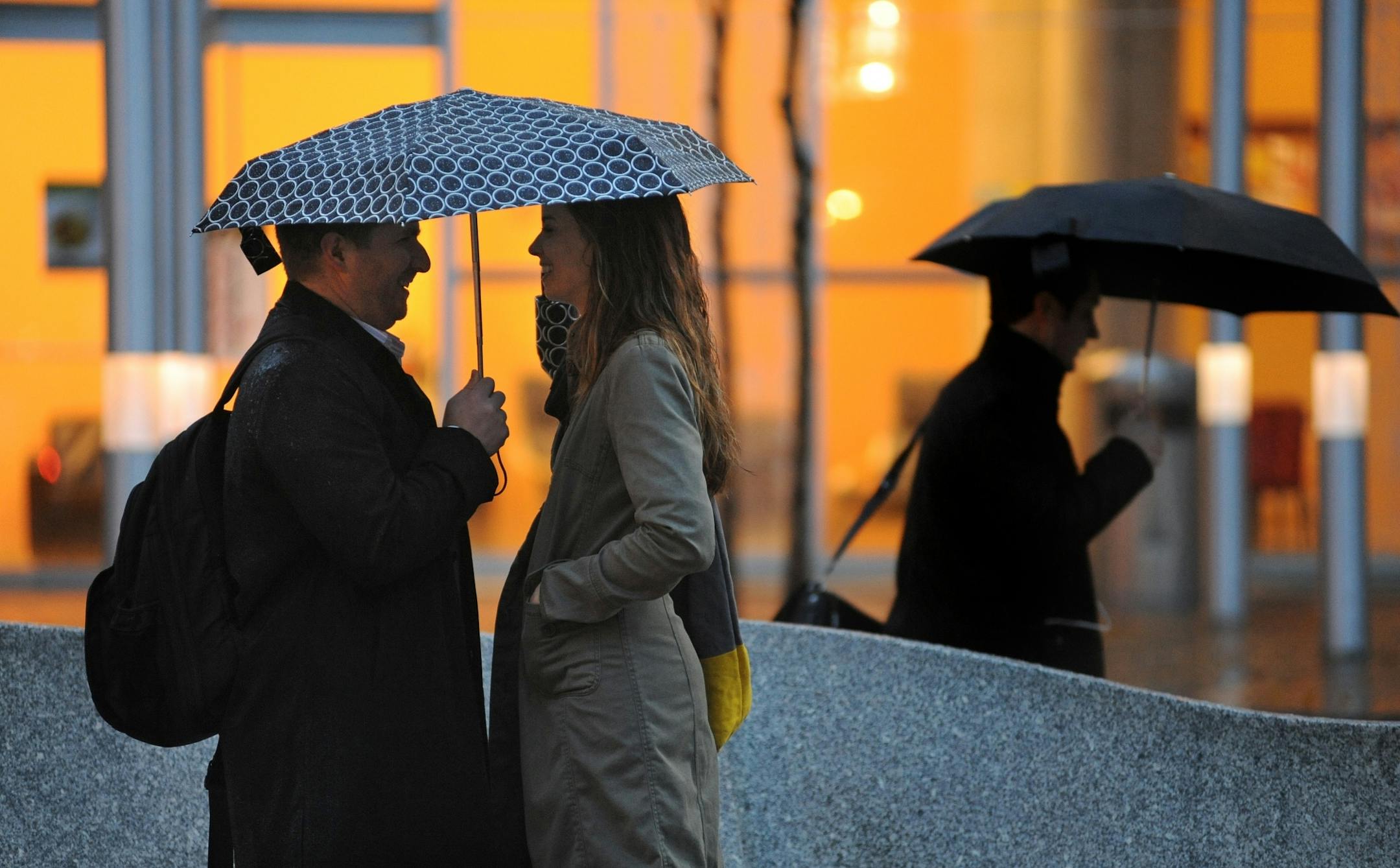Kevin Robledo and his wife, Rebecca, shared an umbrella while waiting for a bus Thursday on Nicollet Avenue in Minneapolis.