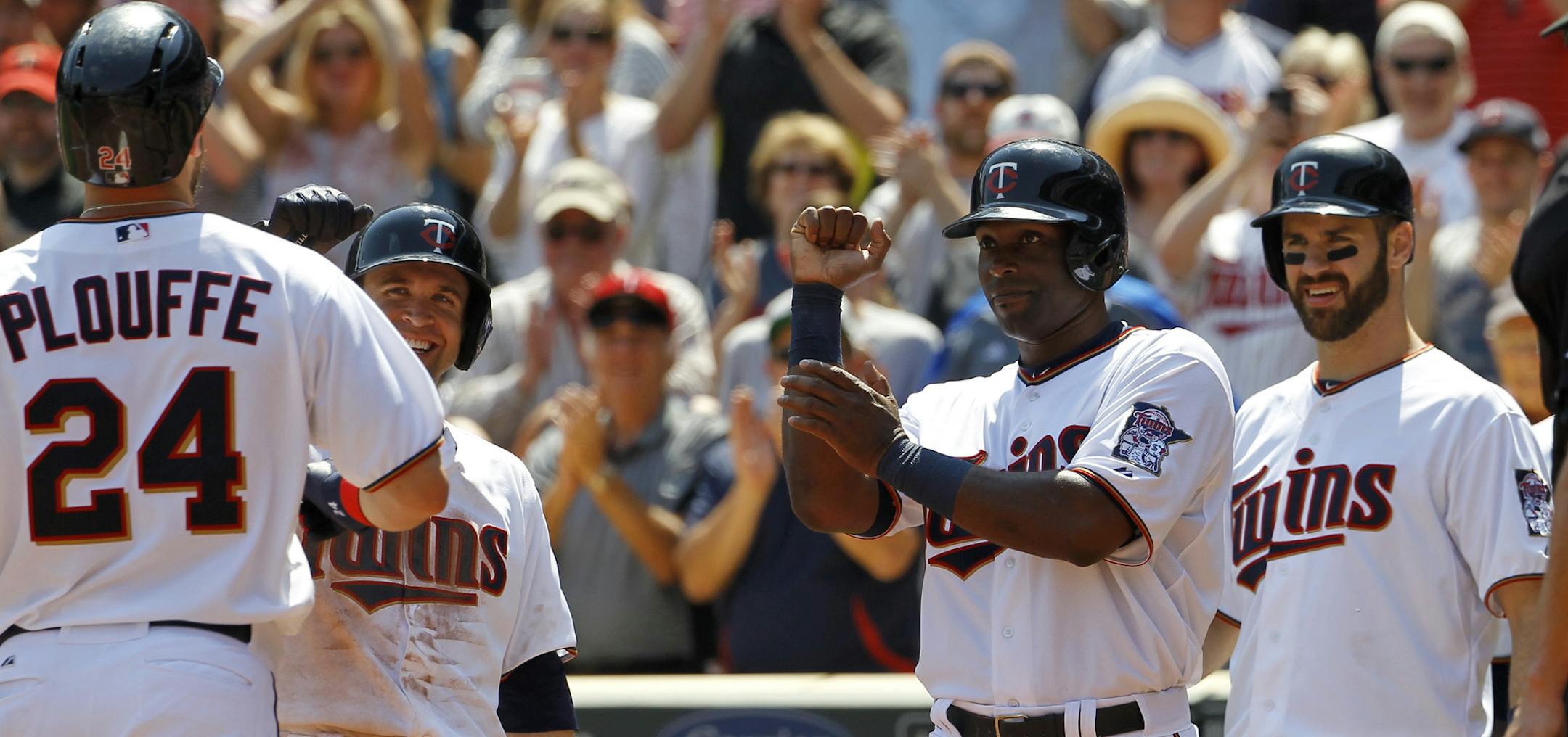 Trevor Plouffe was greeted by teammates Brian Dozier, left, Torii Hunter, center, and Joe Mauer after belting a grand slam off Chicago’s John Danks during a division victory earlier in May.