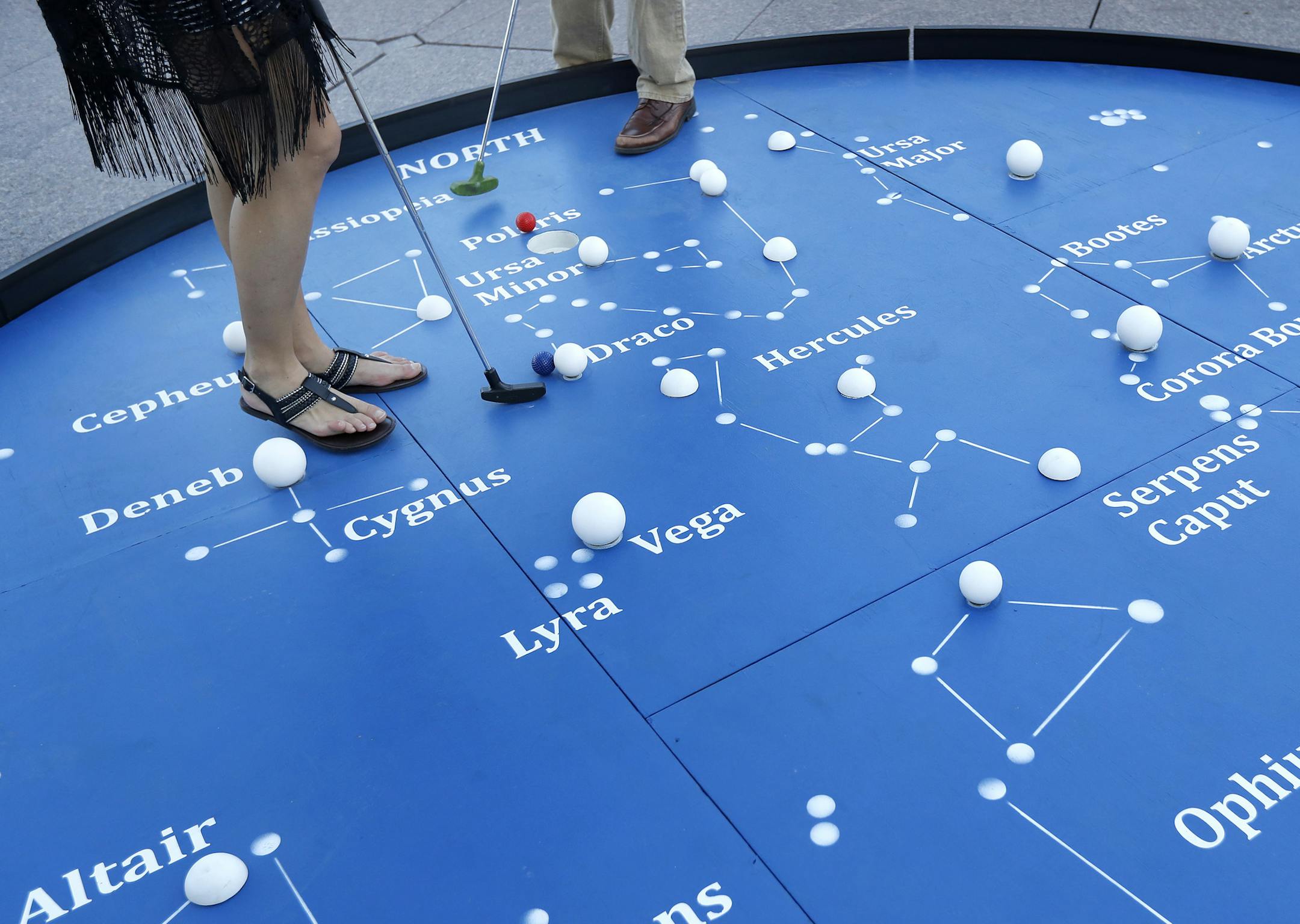 Stephanie Lanik, 25, of Cottage Grove and Steve Sletten, 25, Bloomington played Mini Golf at the Walker Art Center in Minneapolis. ] CARLOS GONZALEZ cgonzalez@startribune.com - May 26, 2016, Minneapolis, MN, It's the first day that Mini Golf at the Walker Art Center is open for the season. It's super cool this year, because it will be Skyline Mini Golf,