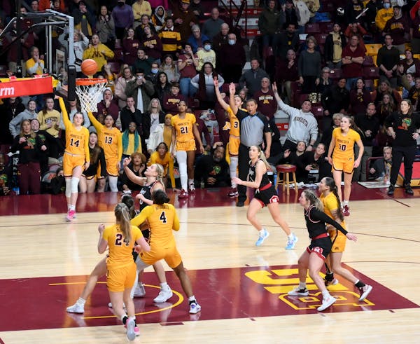 Minnesota guard Isabelle Gradwell (14) hits a 3-pointer to give the Gophers a 95-92 lead over Nebraska with .3 seconds left in the fourth quarter duri