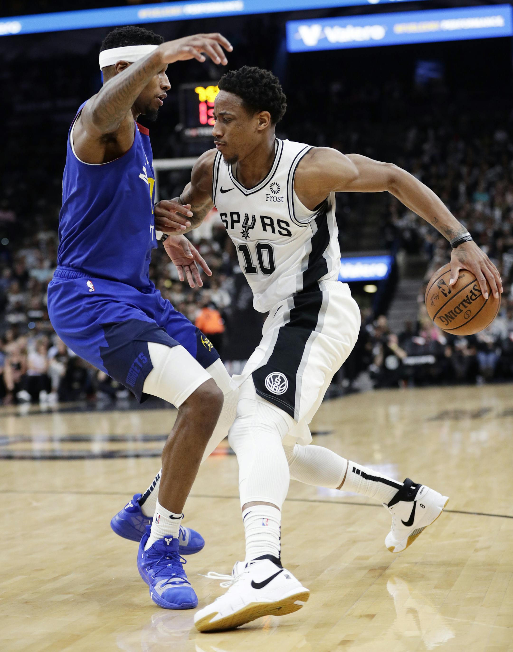 San Antonio Spurs guard DeMar DeRozan (10) drives around Denver Nuggets forward Torrey Craig (3) during the second half of Game 6 of an NBA basketball playoff series, Thursday, April 25, 2019, in San Antonio. San Antonio won 120-103. (AP Photo/Eric Gay)