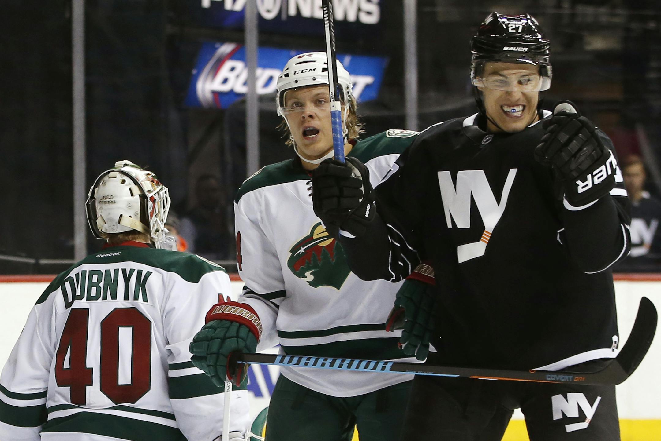 New York Islanders center Anders Lee (27) celebrates after scoring a goal on Minnesota Wild goalie Devan Dubnyk (40) during the second period of an NHL hockey game in New York, Tuesday, Feb. 2, 2016. Wild's Mikael Granlund is at center. (AP Photo/Kathy Willens)