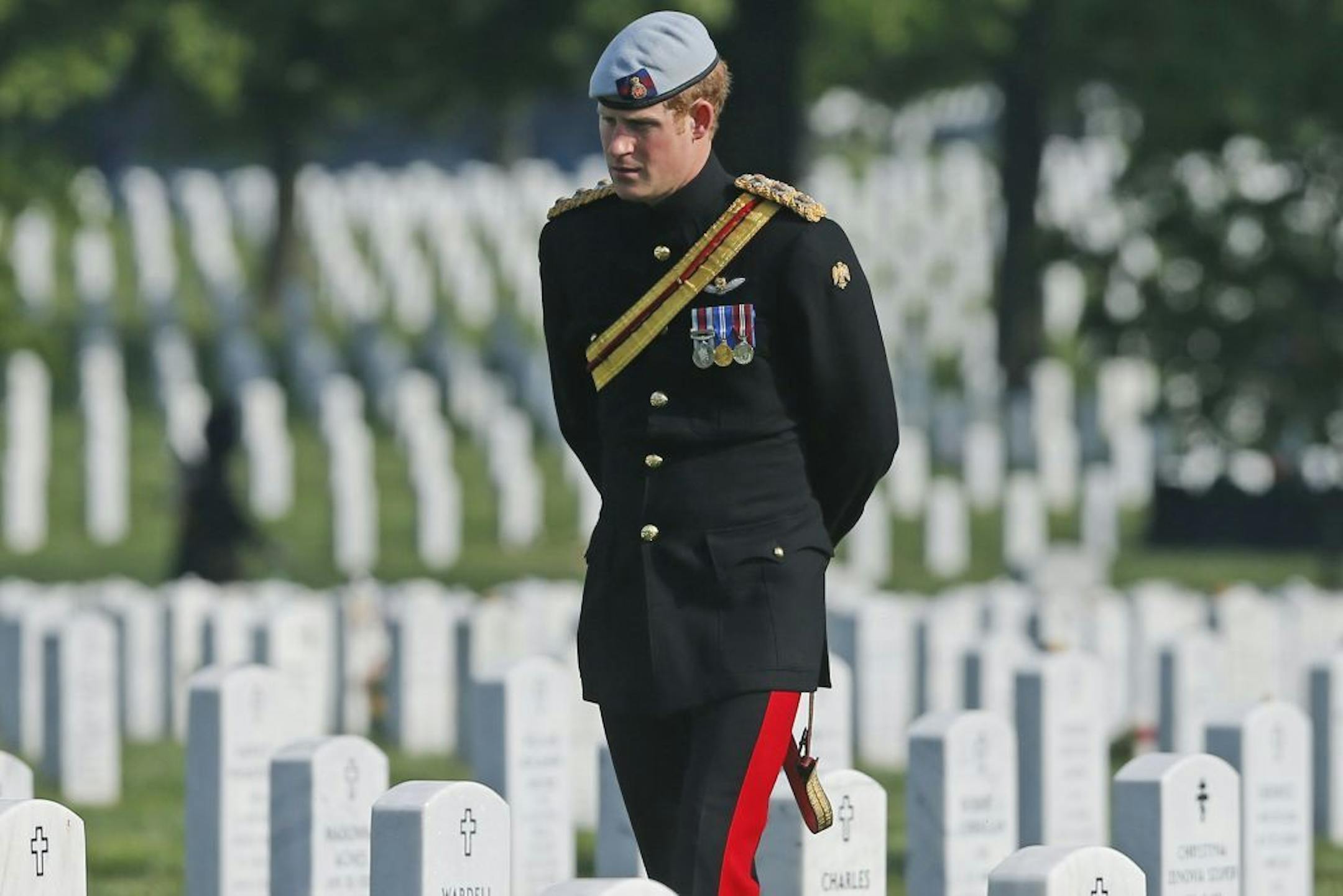 England's Prince Harry visits Section 60 at Arlington National Cemetery, Friday, May 10, 2013. The British soldier-prince is spending most of his week in the U.S. honoring the wounded and the dead of war.