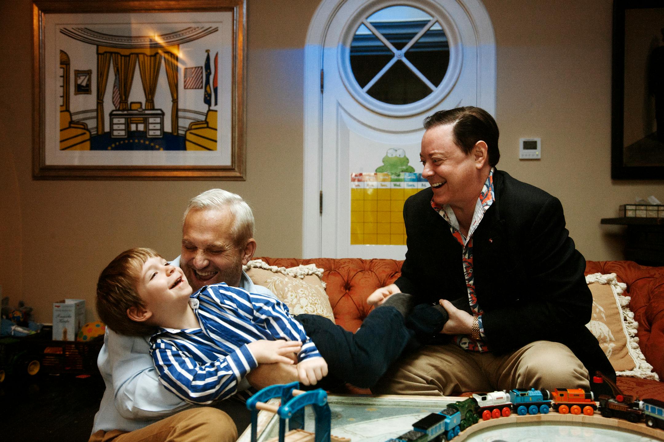 Author Andrew Solomon, right, with his husband, John Habich, and their son, George, 3, at home in New York, Nov. 7, 2012. Solomon's new book, "Far From the Tree: Parents, Children and the Search for Identity" is about children who are born or who grow up as their parents never expected, a subject he knows from experience. (Gabriele Stabile/The New York Times)