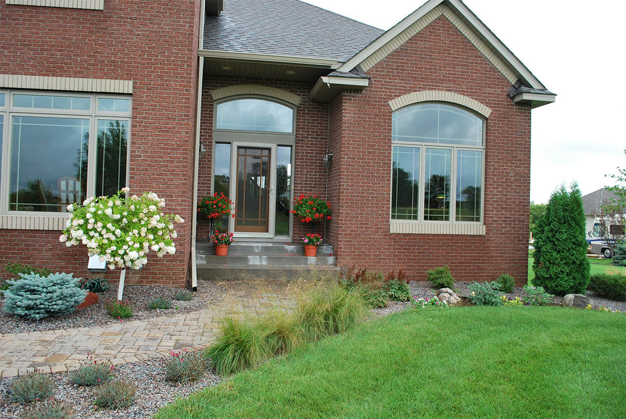 BEFORE: The front of the home before the porch was added.