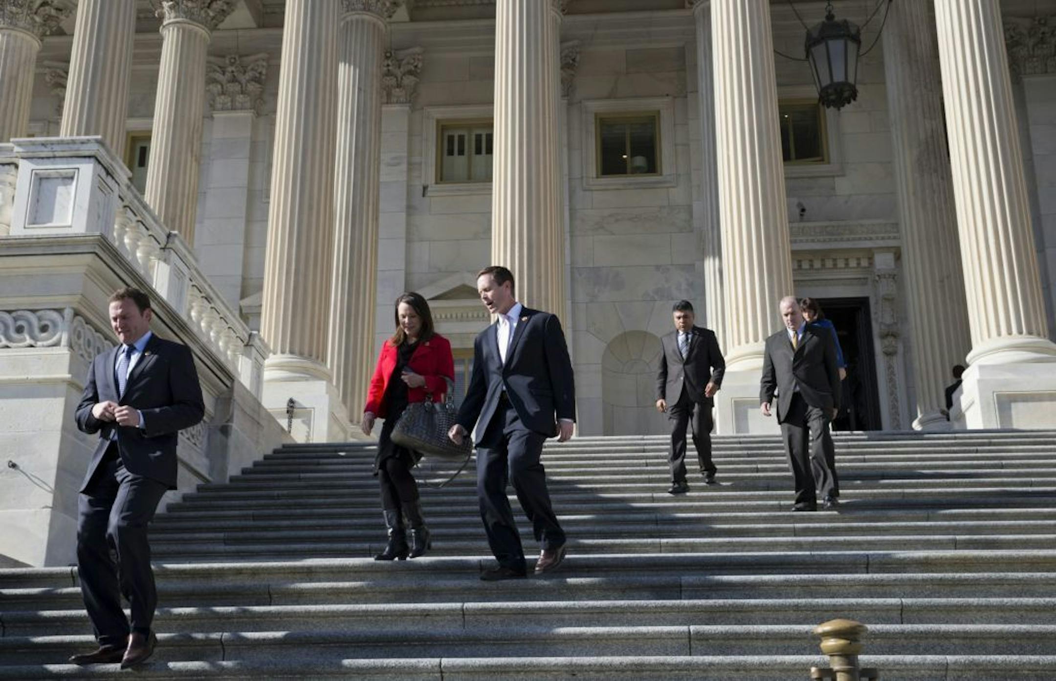 Members of the House of Representatives leave during a series of votes on a measure to let insurers keep offering health coverage that falls short of the law's standards, Friday, Nov. 15, 2013, on Capitol Hill in Washington.