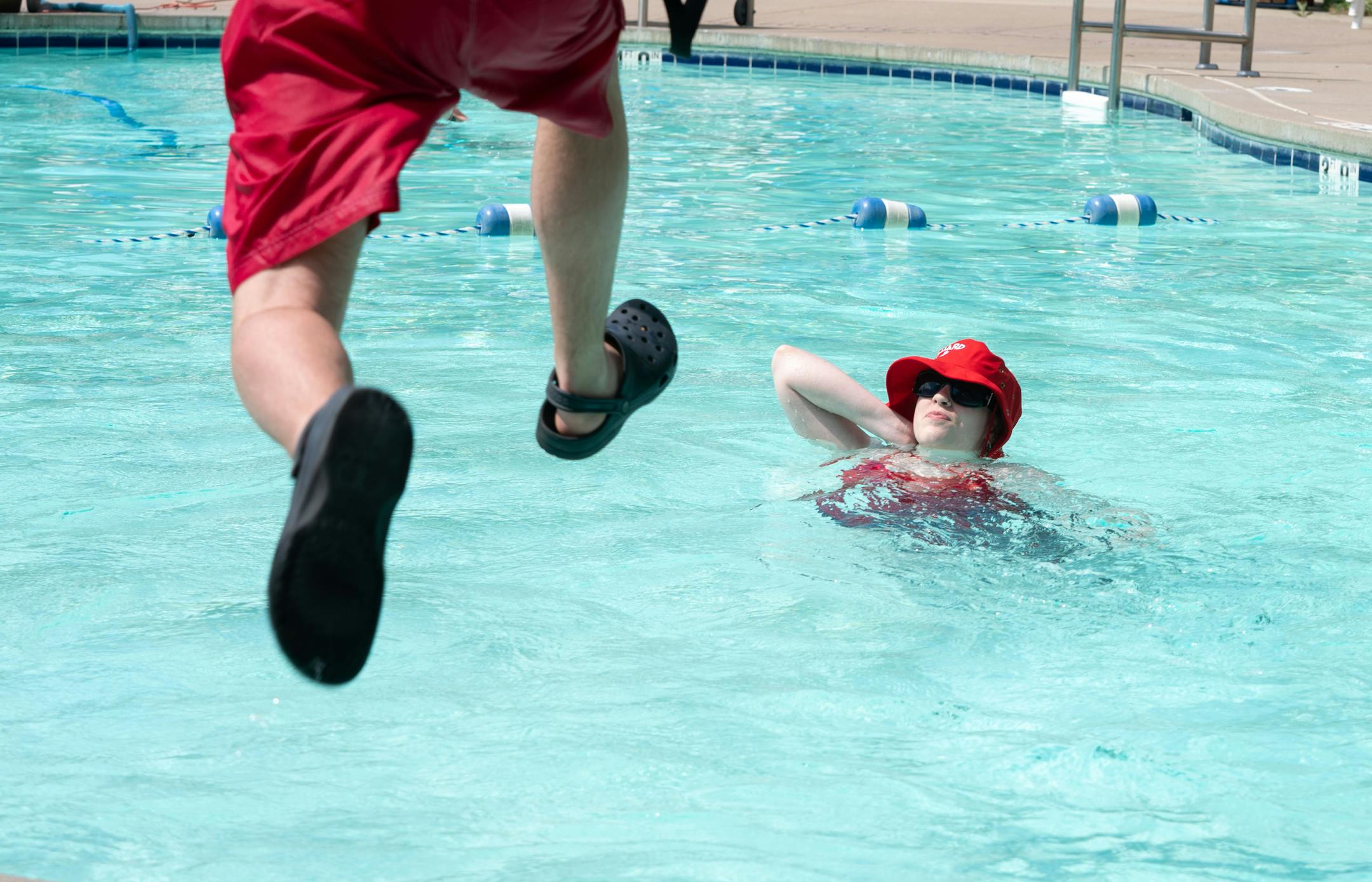 Lifeguard-in-training Mathias Hoke, left, jumps in the water to rescue Karinna Borgstrom in an exercise                   during a training program for new Ramsey County lifeguards.