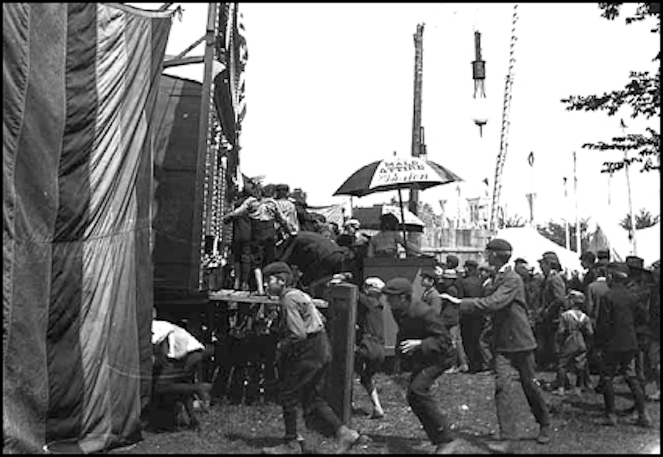 Boys sneaking into a sideshow at the Minnesota State Fair in about 1910.