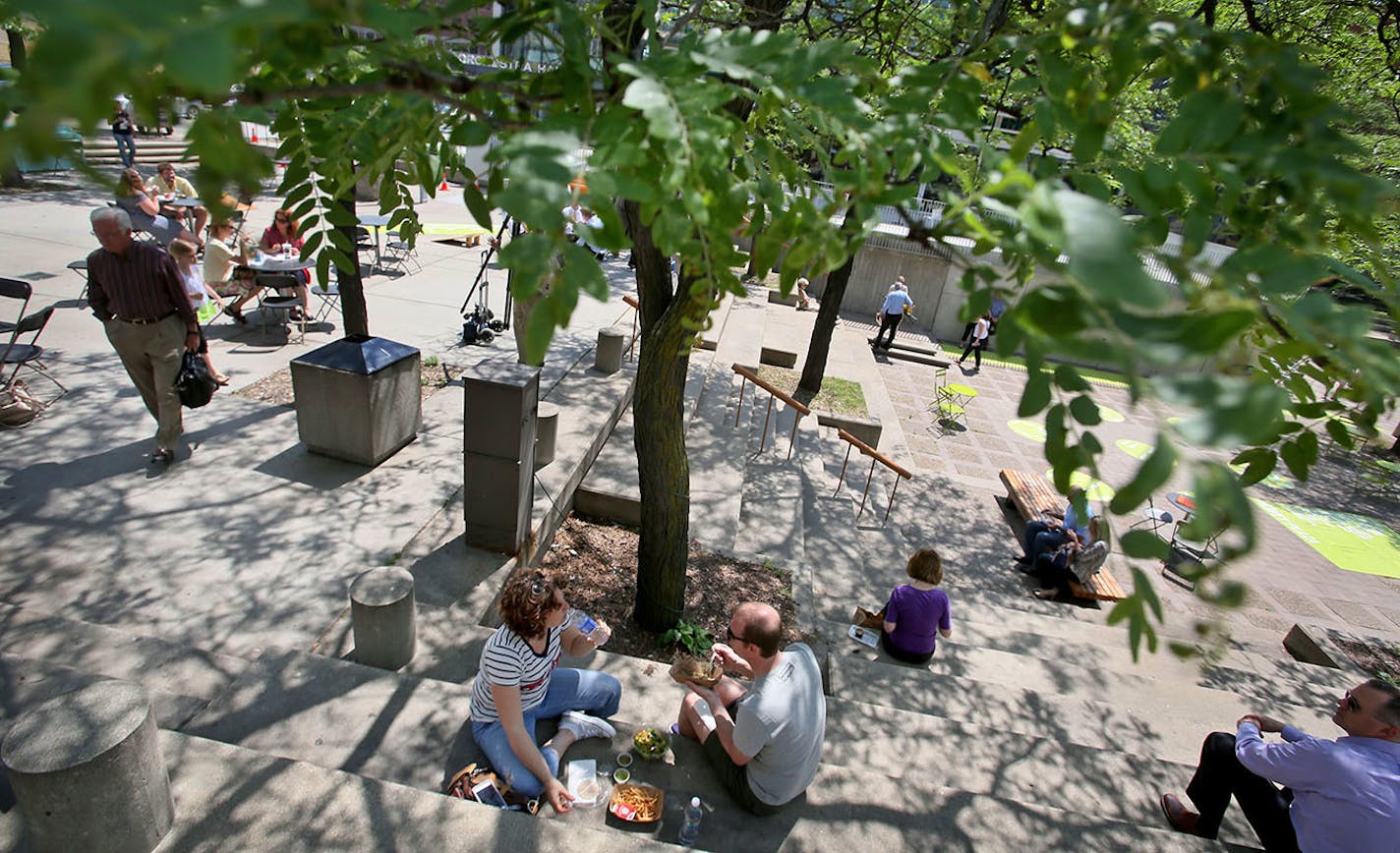 Minneapolis officials and downtown business leaders announced future plans for Peavey Plaza Wednesday, June 10, 2015, in Minneapolis, MN. The plans were vague and did not include funding but organizers said they hoped with a remake the plaza could again become a city square and popular gathering place like it was when the plaza was built in the early 70s. Here, people enjoyed the plaza over around noon.](DAVID JOLES/STARTRIBUNE)djoles@startribune.com Minneapolis officials and downtown business l