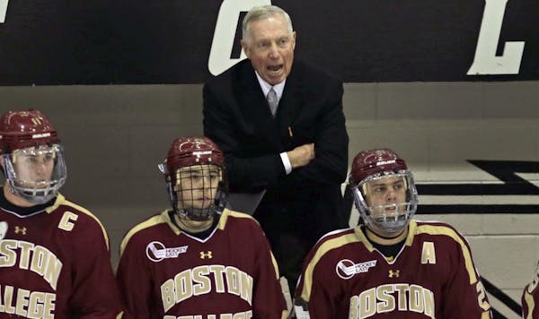 Boston College coach Jerry York calls in at his players during the first period against Providence College in an NCAA college hockey game in Providenc