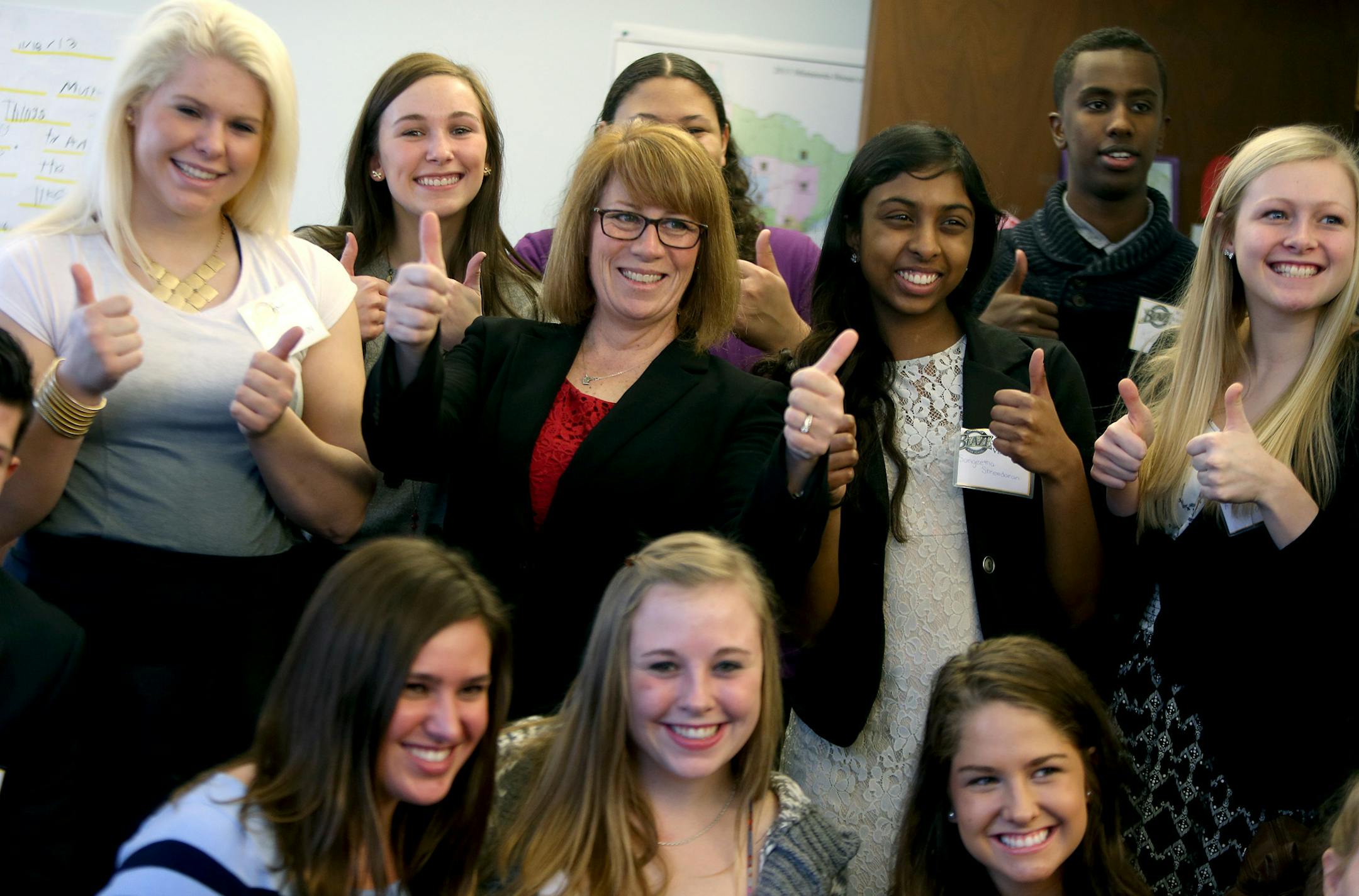Burnsville High School students gave a thumbs up along with Representative Erin Murphy, center, after they discussed a bill in her office, Tuesday, March 11, 2014. Students had the assignment of researching a bill and then going to the Capitol and State Office Building to meet with the authors of the bill to discuss it. Throughout the year they also have other "hands-on" experiences with government, like volunteering to work on a campaign and manning the polls on election day. ] (ELIZABETH FLORE