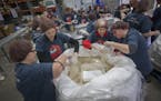 Volunteers from left, Maria Kreidermacher, cq, Sara Grasmon, Muffie Foreman and Erika Finne joined The Current staff to help pack rice at Second Harve