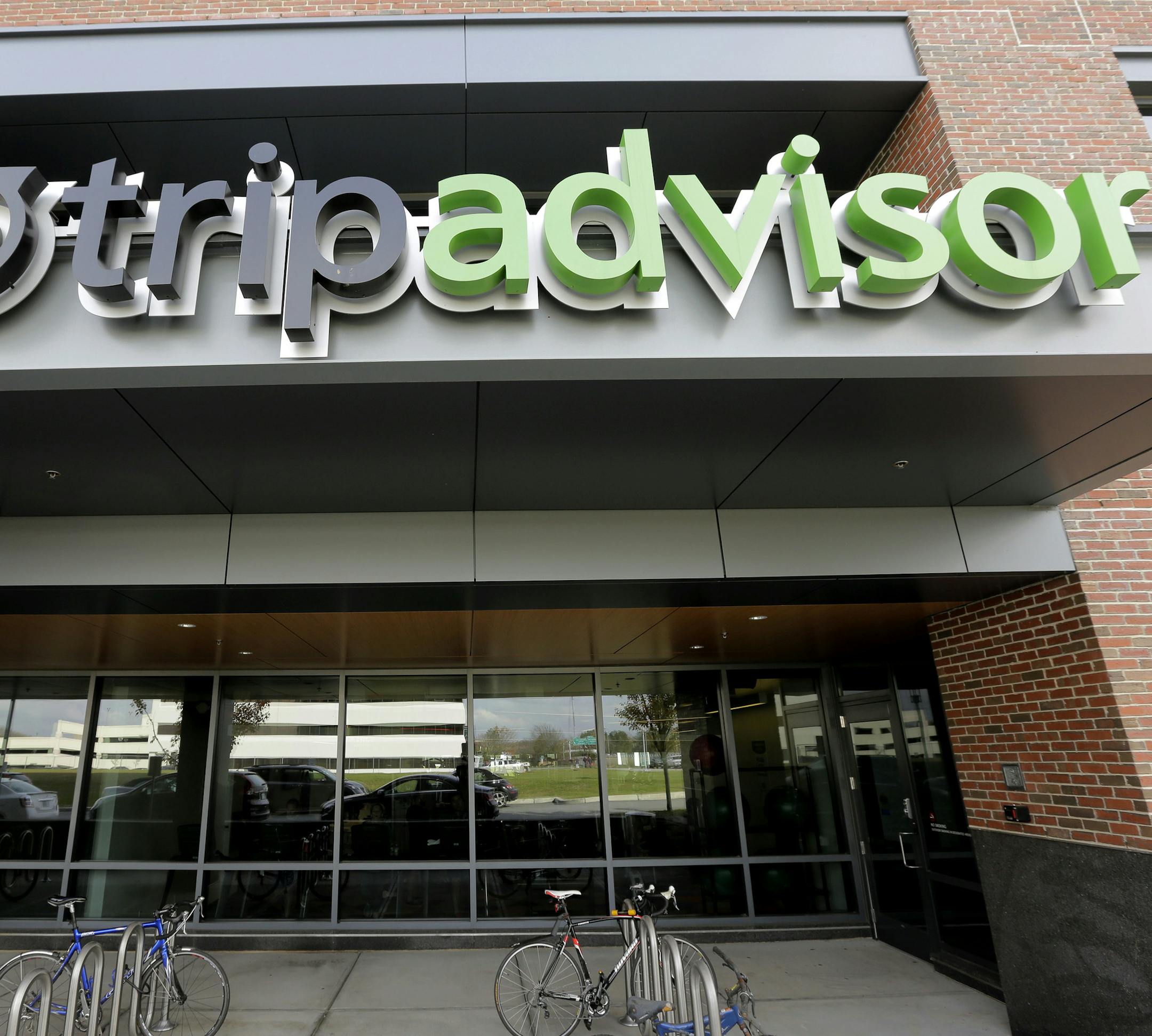 Corporate signage for the travel website TripAdvisor is seen at the company's headquarters, Thursday, Nov. 2, 2017, in Needham, Mass. TripAdvisor says it has changed its rules about reviews that contain allegations of rape or other crimes, following a published report that quoted several users who said such postings were deleted. (AP Photo/Steven Senne) ORG XMIT: MASR402