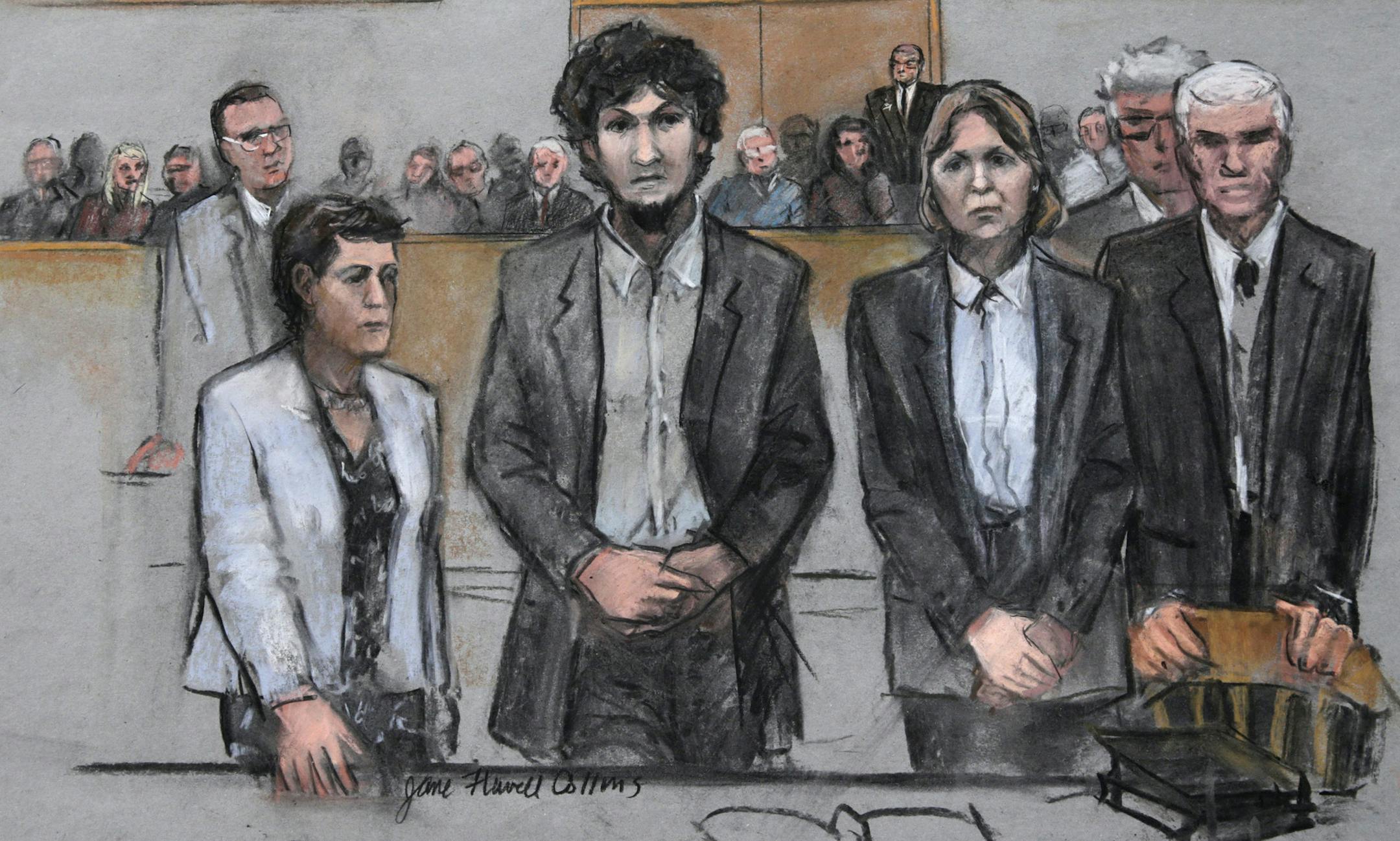 In this courtroom sketch, Boston Marathon bomber Dzhokhar Tsarnaev, center, stands with his defense attorneys as a death by lethal injection sentence is read at the Moakley Federal court house in the penalty phase of his trial in Boston, Friday, May 15, 2015. The federal jury ruled that the 21-year-old Tsarnaev should be sentenced to death for his role in the deadly 2013 attack. (Jane Flavell Collins via AP)
