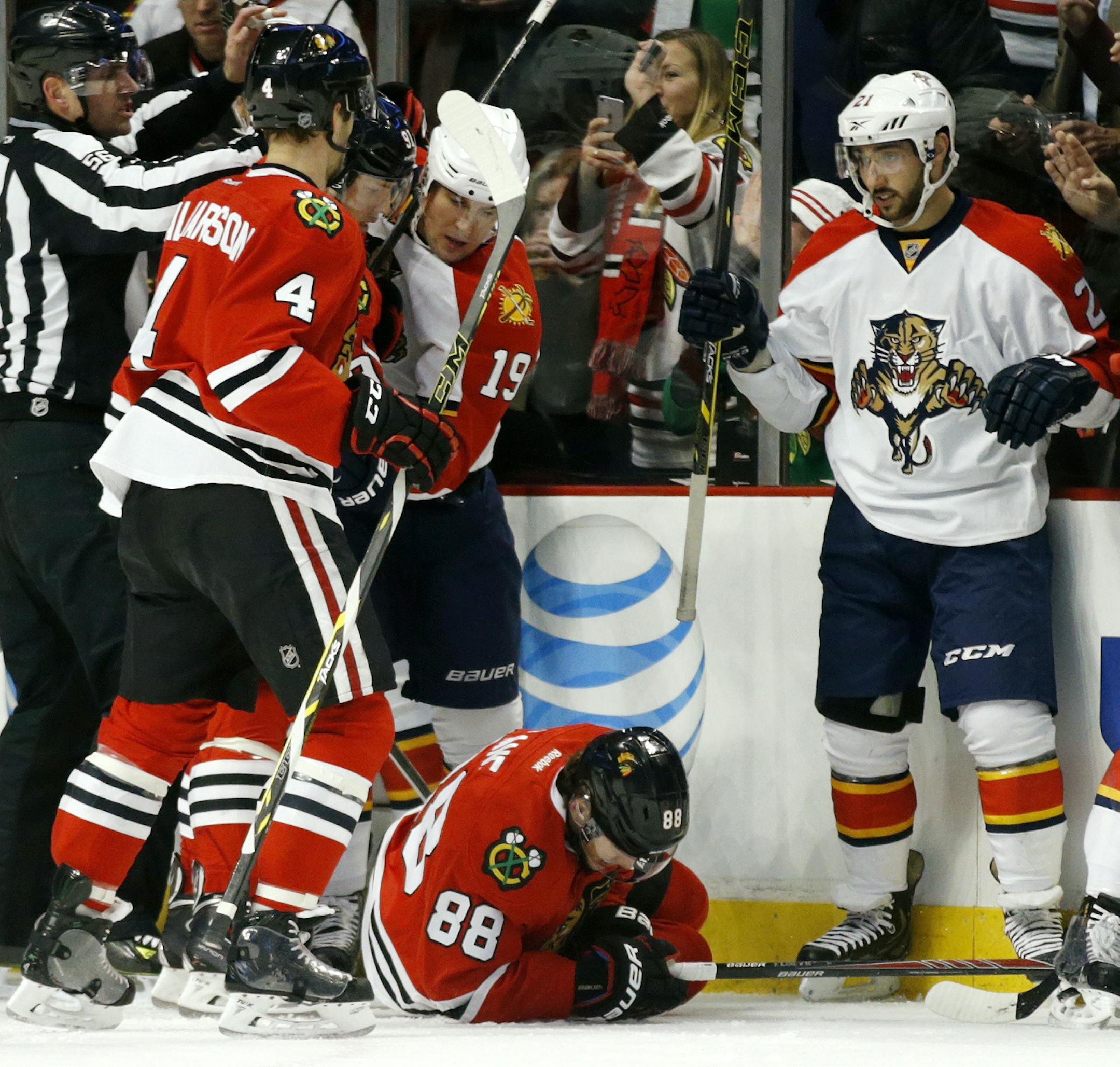 Chicago Blackhawks right wing Patrick Kane (88) picks himself up off the ice after sustaining an injury during the first period of an NHL hockey game against the Florida Panthers on Tuesday, Feb. 24, 2015, in Chicago. (AP Photo/Andrew A. Nelles)