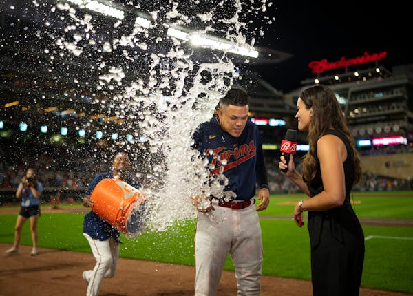 Minnesota Twins third baseman Gio Urshela (15 ) was given an ice water shower courtesy of teammate Luis Arraez (2) during his post-game interview with