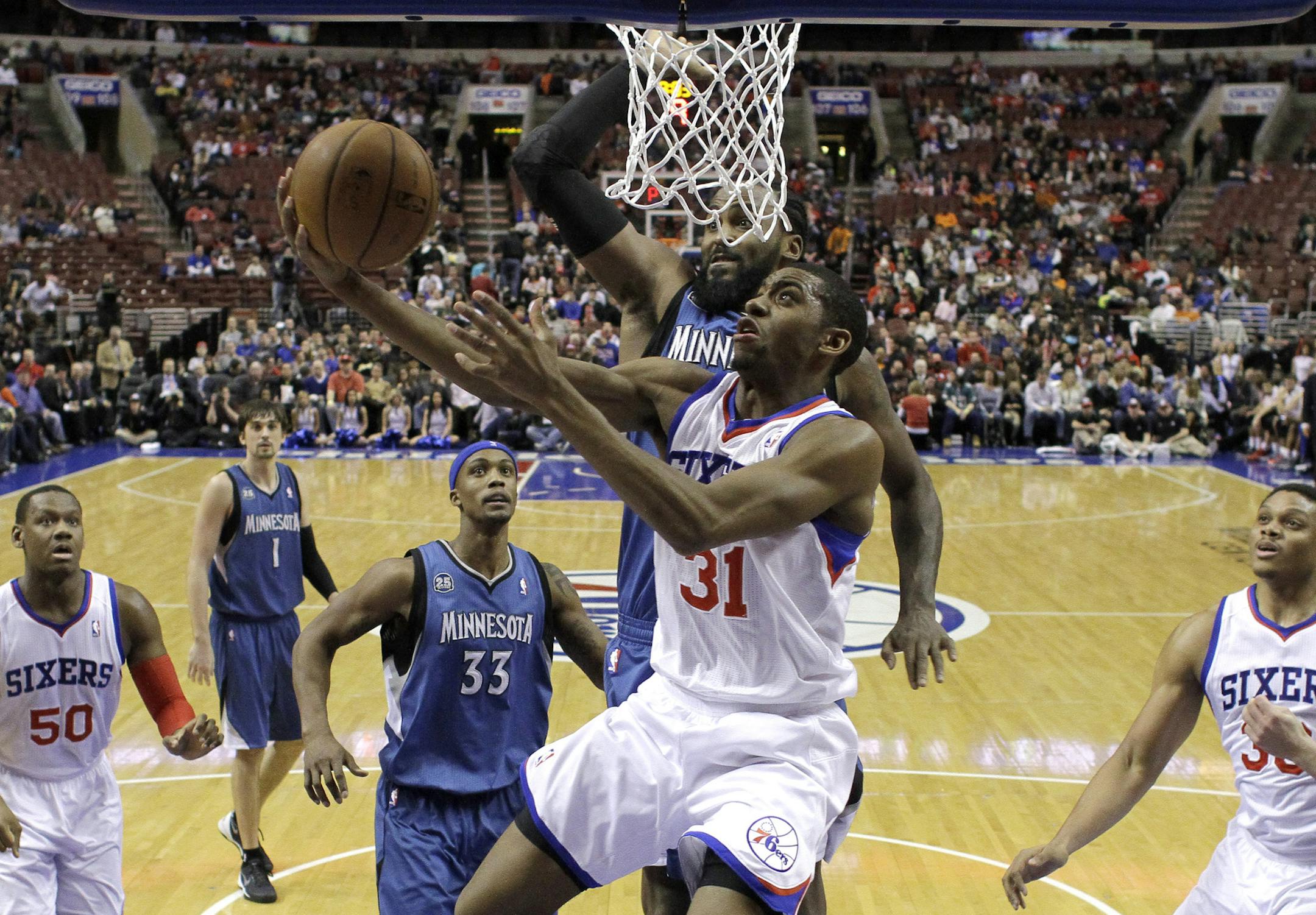 Philadelphia 76ers' Hollis Thompson (31) goes up for a shot against Minnesota Timberwolves' Ronny Turiaf, of France, during the second half of an NBA basketball game, Monday, Jan. 6, 2014, in Philadelphia. Minnesota won 126-95. (AP Photo/Matt Slocum)