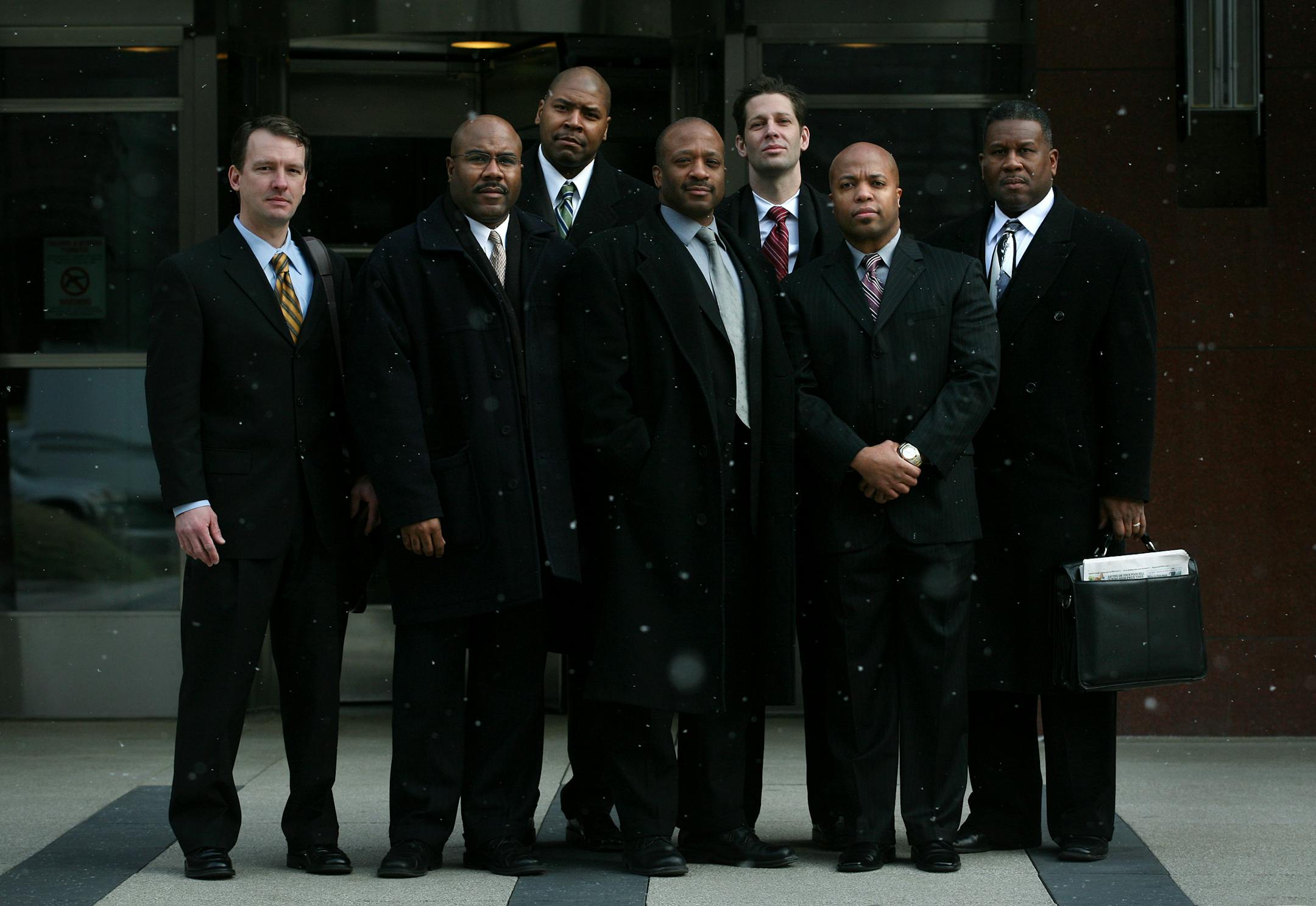 The five African-American Minneapolis police officers who are suing the city's police department made their first appearance on Thursday. From the left, they are: Sgt. Charles Adams, Sgt. Dennis Hamilton, Lt. Don Harris, Lt. Medaria Arradondo and Lt. Lee Edwards. With them are attorneys John Klassen, left, and Andrew Muller, back right.