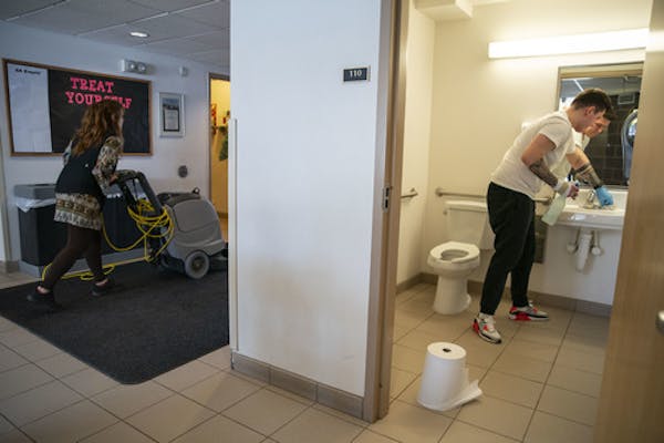 (Left) Beth Lisak, a housekeepr in the apartments on the College of St. Scholastica's campus, and Corey Bullheller, a senior, worked on deep cleaning 