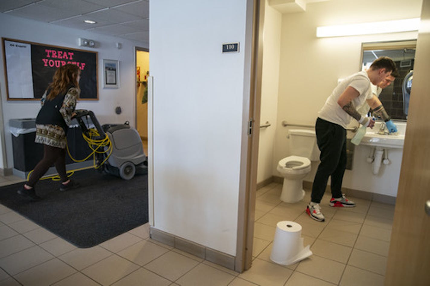 (Left) Beth Lisak, a housekeepr in the apartments on the College of St. Scholastica's campus, and Corey Bullheller, a senior, worked on deep cleaning and disinfecting Cedar Apartments on Tuesday. ] ALEX KORMANN • alex.kormann@startribune.com The College of St. Scholastica professors have been preparing for teaching their classes online which has unique challenges for different departments such as science and music.