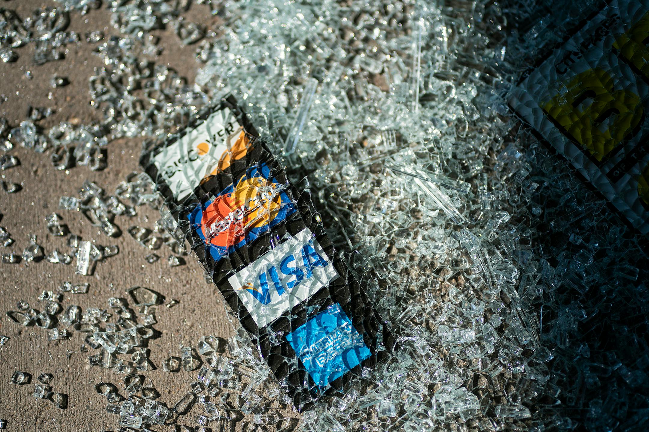 Shattered glass rested on the sidewalk in front of the Uptown Theater.