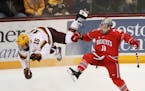 The University of Minnesota's Rem Pitlick (15) and Ohio State University's Christian Lampasso (18) go airborne after colliding in the second period Fr