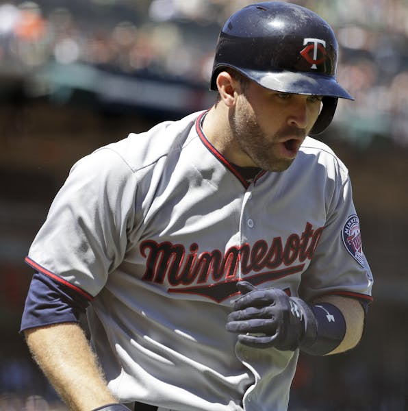 Minnesota Twins' Brian Dozier celebrates as he runs back to the dugout following his two-run home run against the San Francisco Giants during the fift