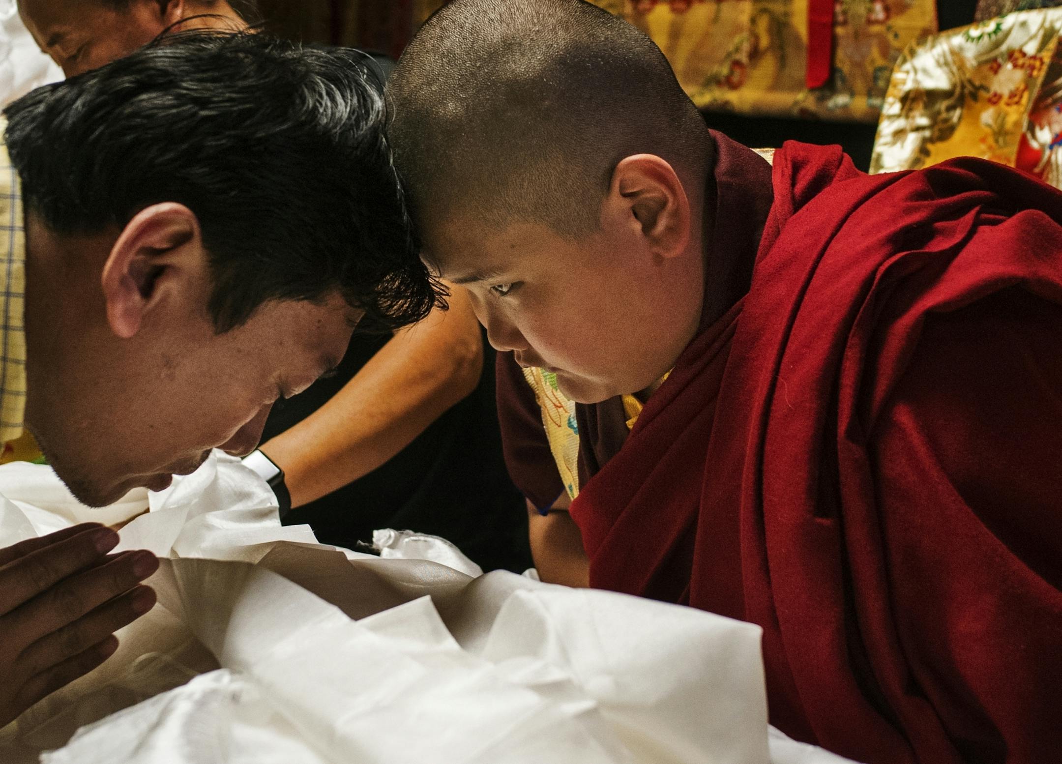 Jalue Dorjee,9, blesses one of the hundreds of Tibetans who attended a religious ceremony at the Tibetan American Foundation in St. Paul.