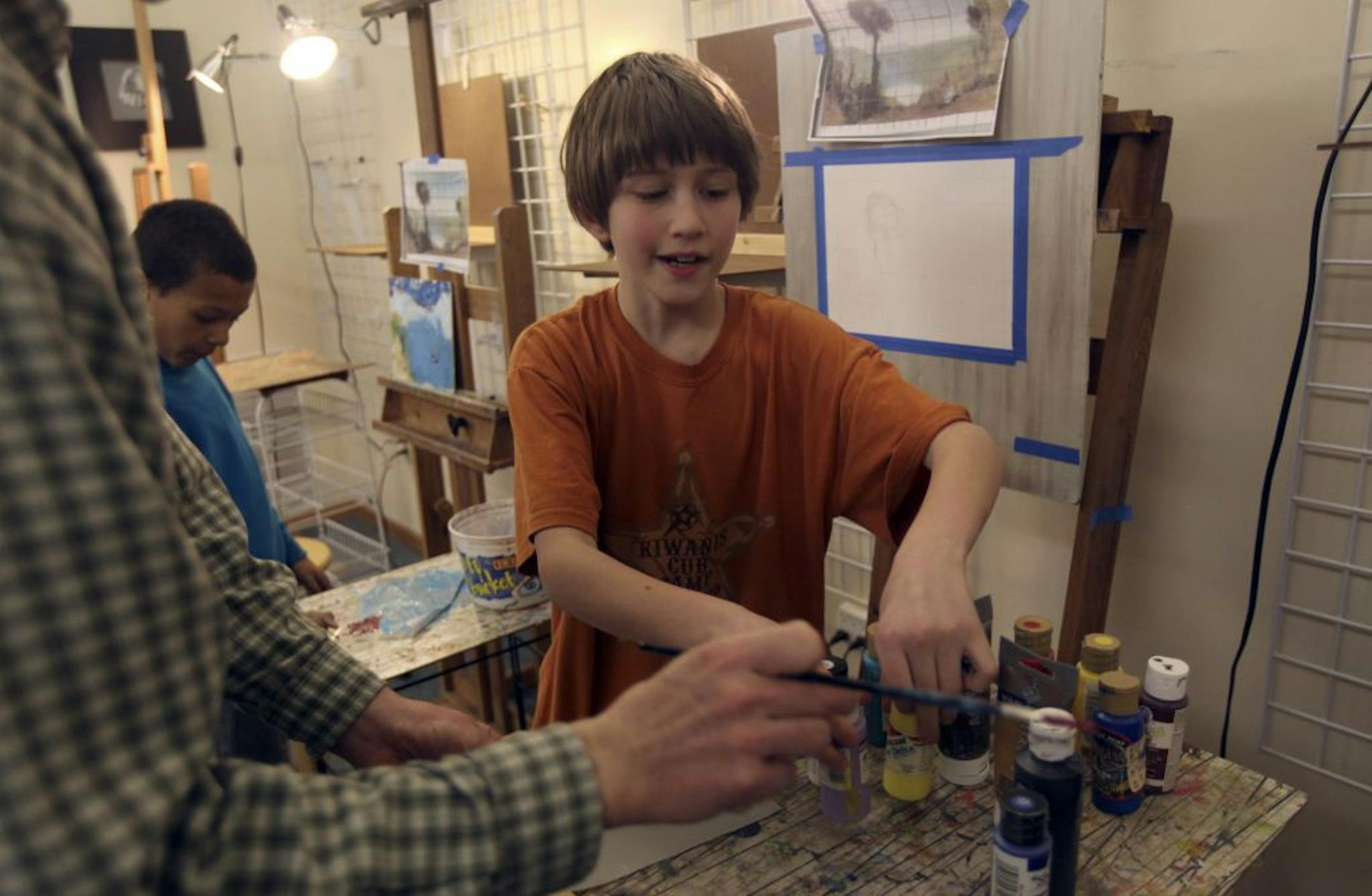 with the help of teacher Nelson Anderson, Aidan Dunleavy, 10, prepared to paint his landscape during a kids art class at Savage Art Studios in Savage Min., Thursday, February 9, 2012.