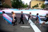 A trans-gender flag was carried down Hennepin at the front of the pride parade on Sunday.