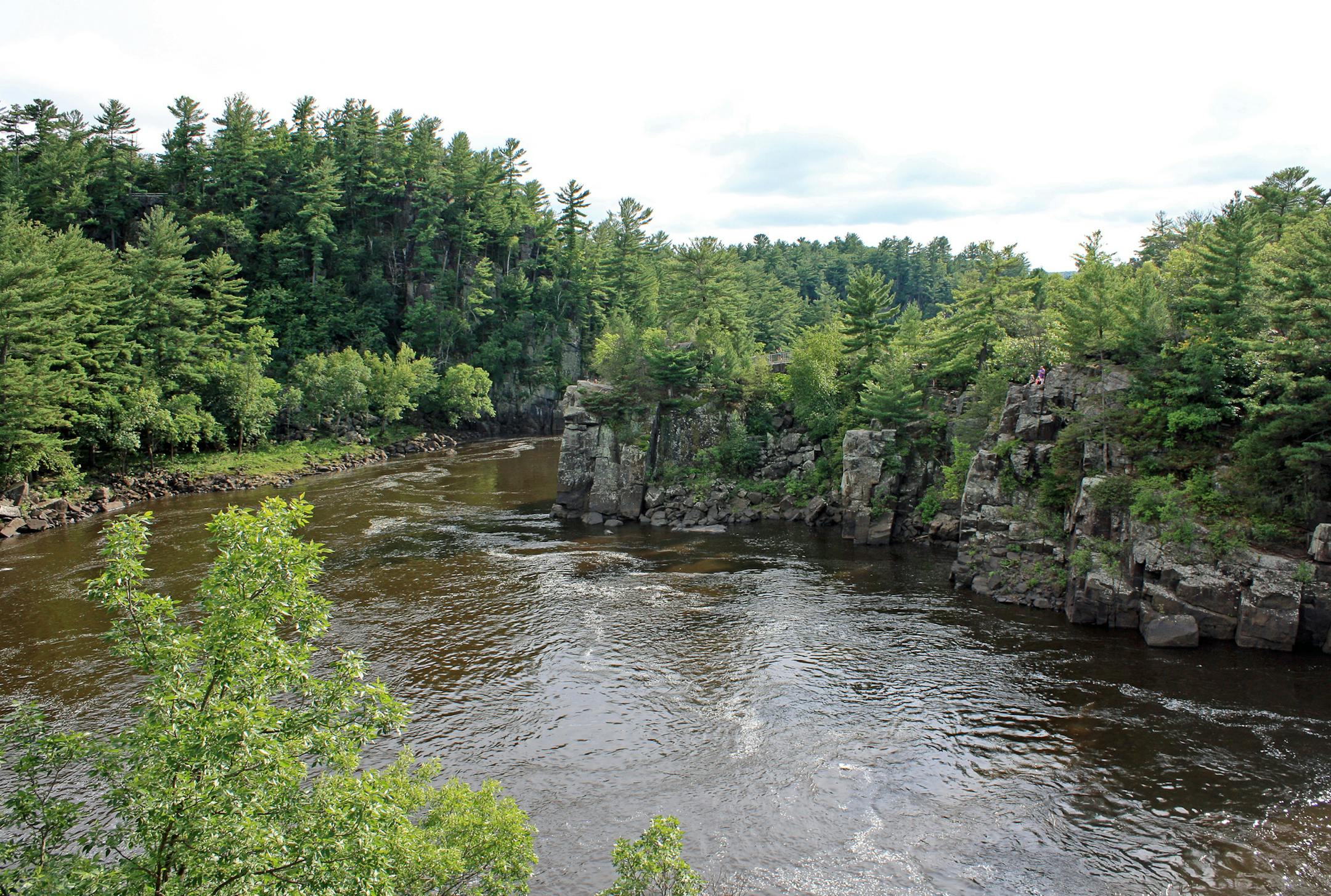 The river cuts through a basalt gorge known as the Dalles of the St. Croix. The dramatic rock walls are part of Interstate State Park — both on the Wisconsin and Minnesota sides of the river.