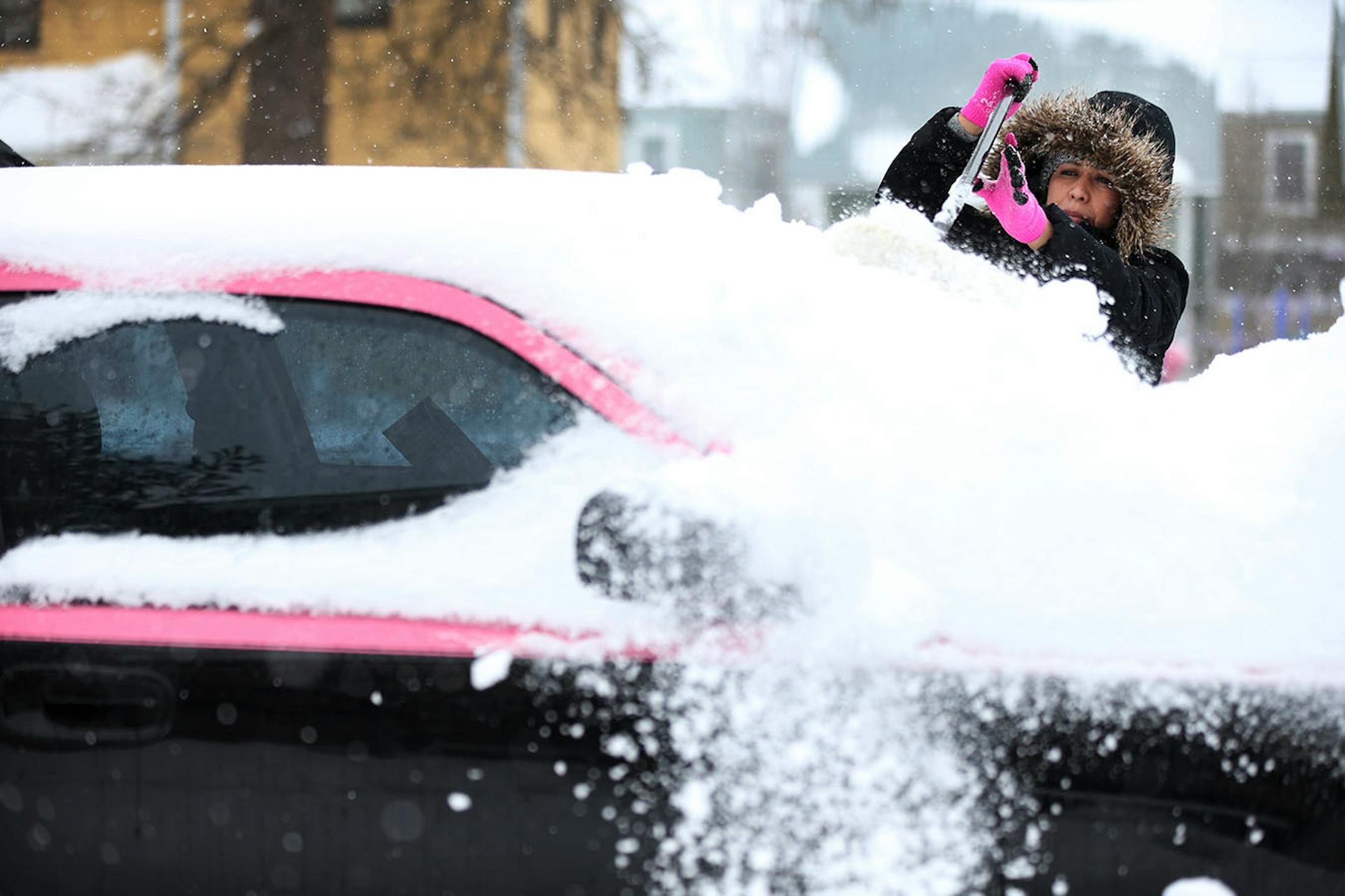 Natalie Osorio removed snow from her 2006 Dodge in the 2100 block of Portland Avenue. Natalie did not drive her newly painted car all winter.
