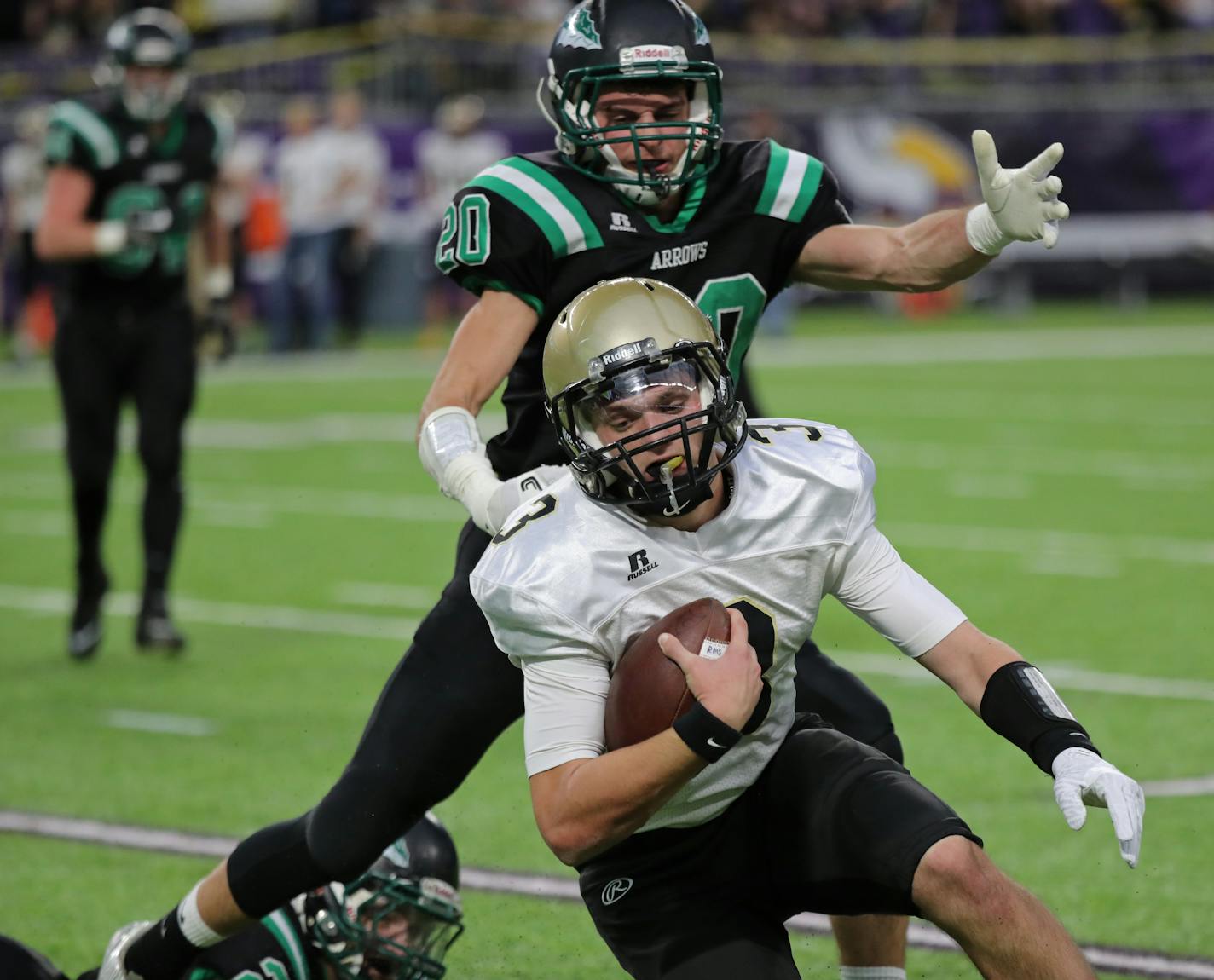 Caledonia quarterback Owen King scrambled away from Pipeston's Tyl Woelber in the first half.