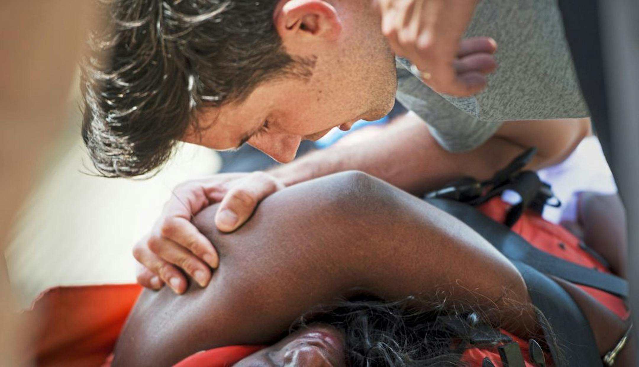 Major league umpire John Tumpane consoles a woman he had seen hop over a railing along the Roberto Clemente Bridge over the Allegheny River, Wednesday, June 28, 2017, in Pittsburgh.