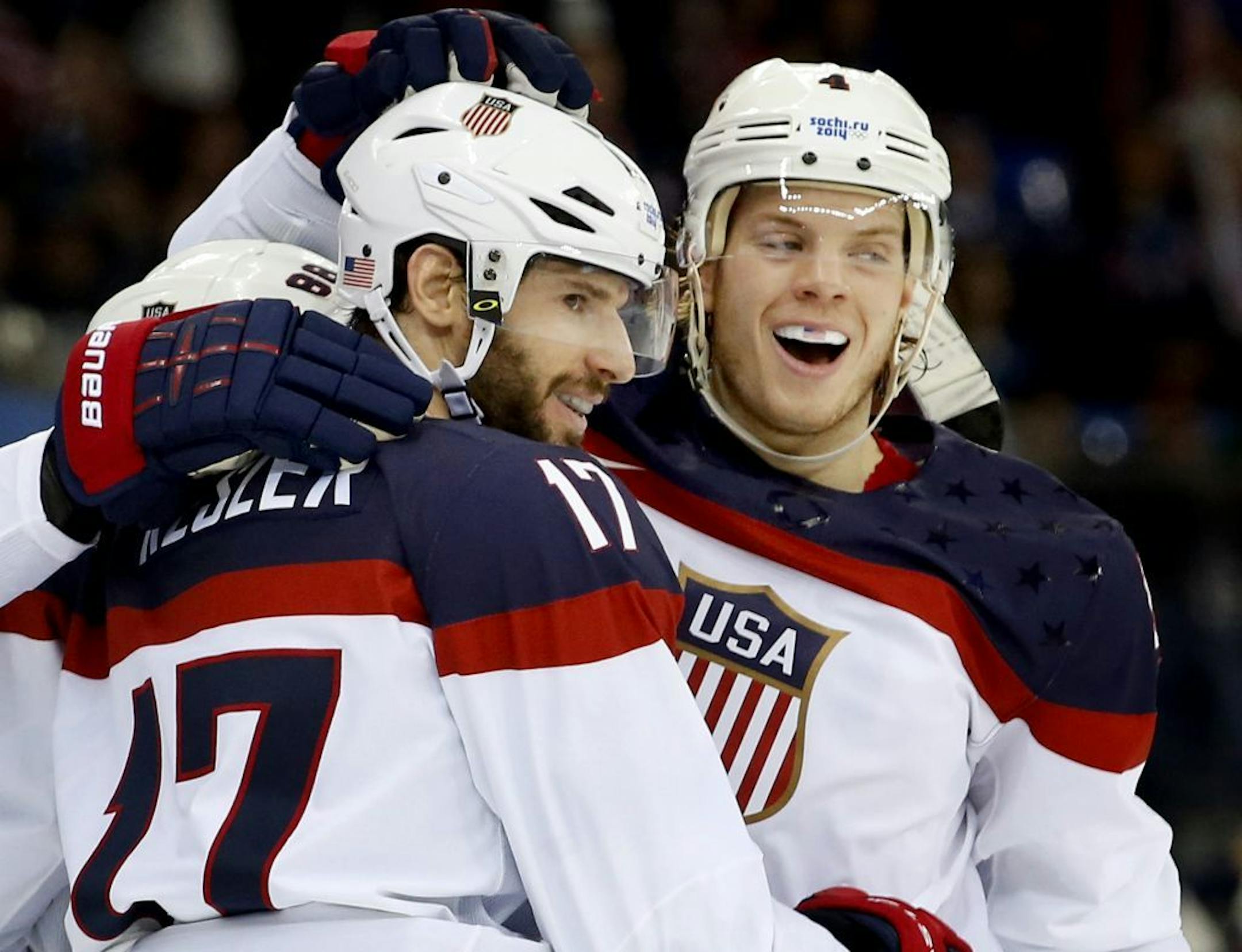 Ryan Kesler (17) and John Carlson (4) celebrated a goal by Kesler in the second period. USA beat Slovakia by a final score of 7-1.