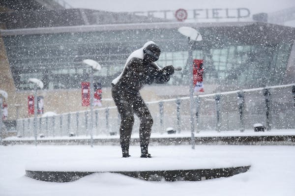A statue of former Twin and multiple time All-Star selection Rod Carew is coated in fresh snow Tuesday, April 3, 2018, in Minneapolis, MN, hours befor