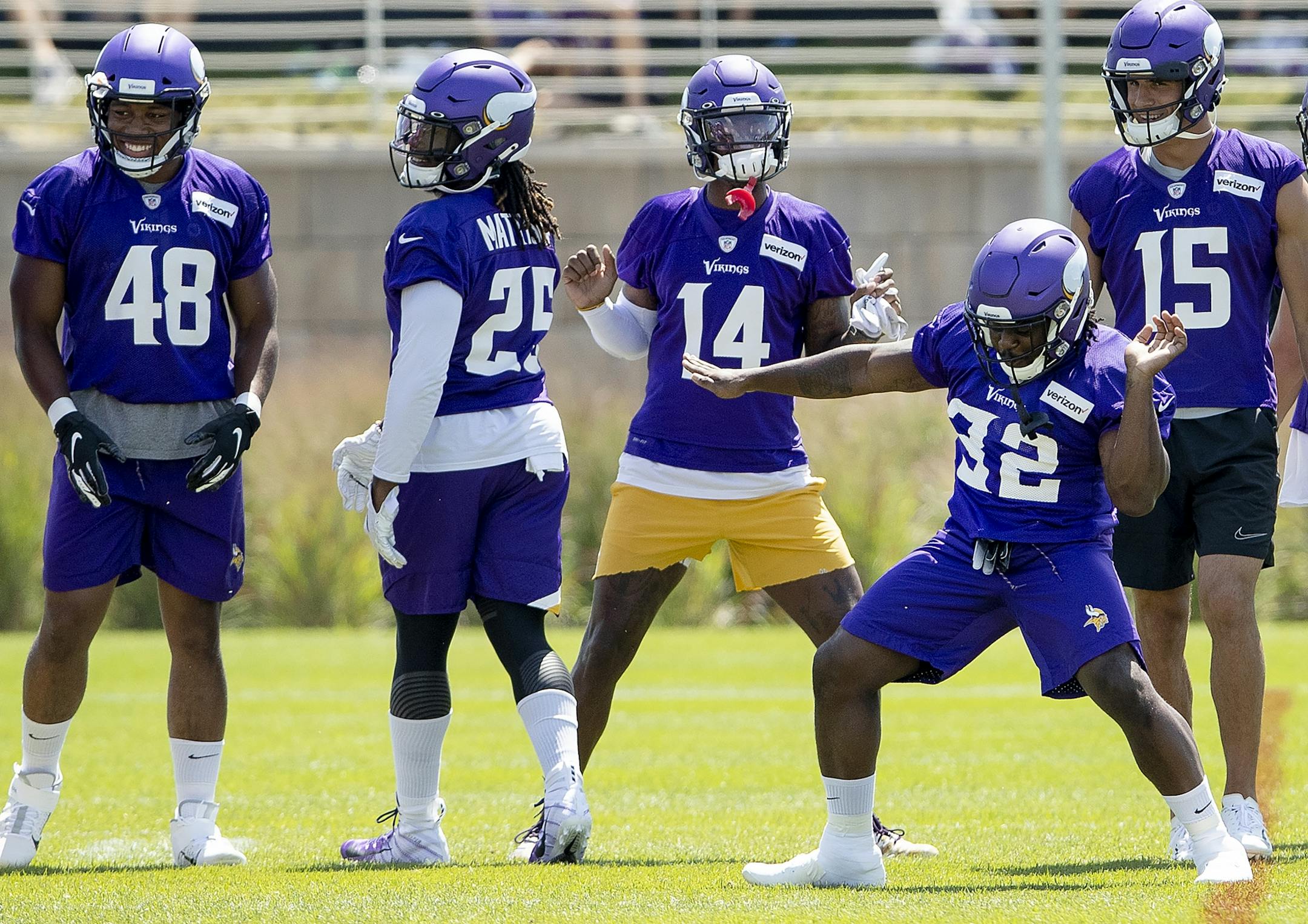 Stefon Diggs (14) and De'angelo Henderson (32) danced during team warm-ups before a practice this week.