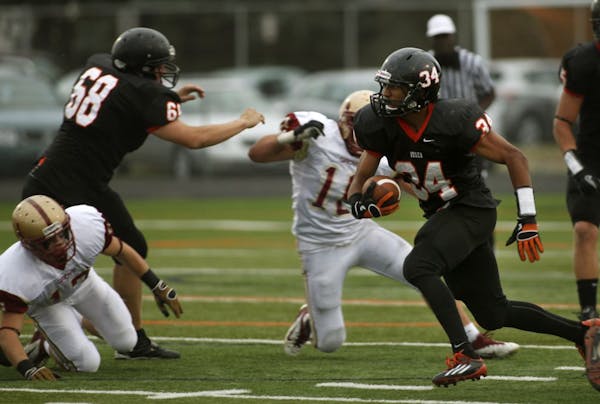 Runningback Bridgeport Tusler (34) of Osseo is one of three football players who play for the boys' basketball team. The others are D.J. Hebert and Wi