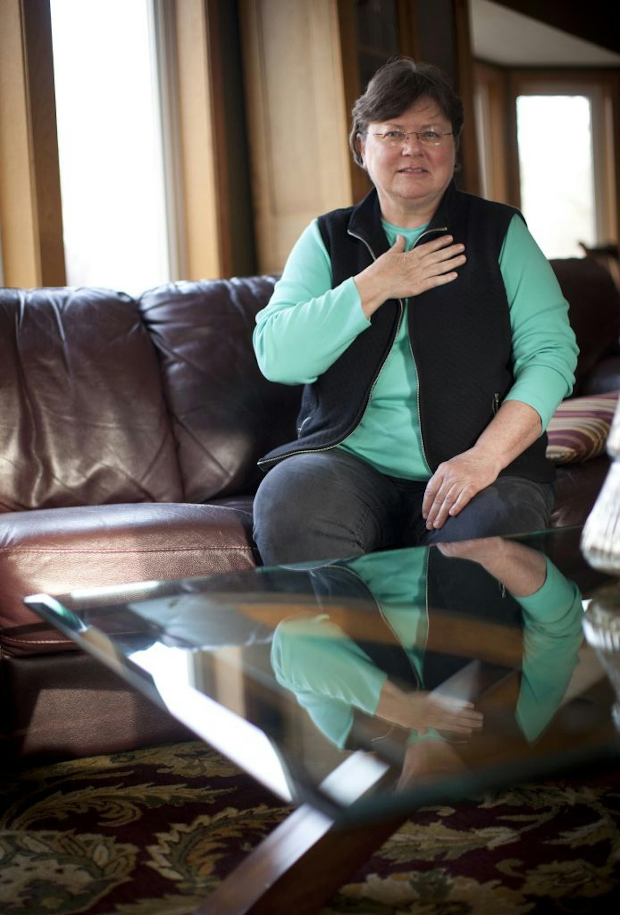 Terrie Pearson had a Unify Quadra cardiac defibrillator implanted in her heart earlier this month. She posed for a picture holding her heart in her home in Farmington, Minn. on December 29, 2011.