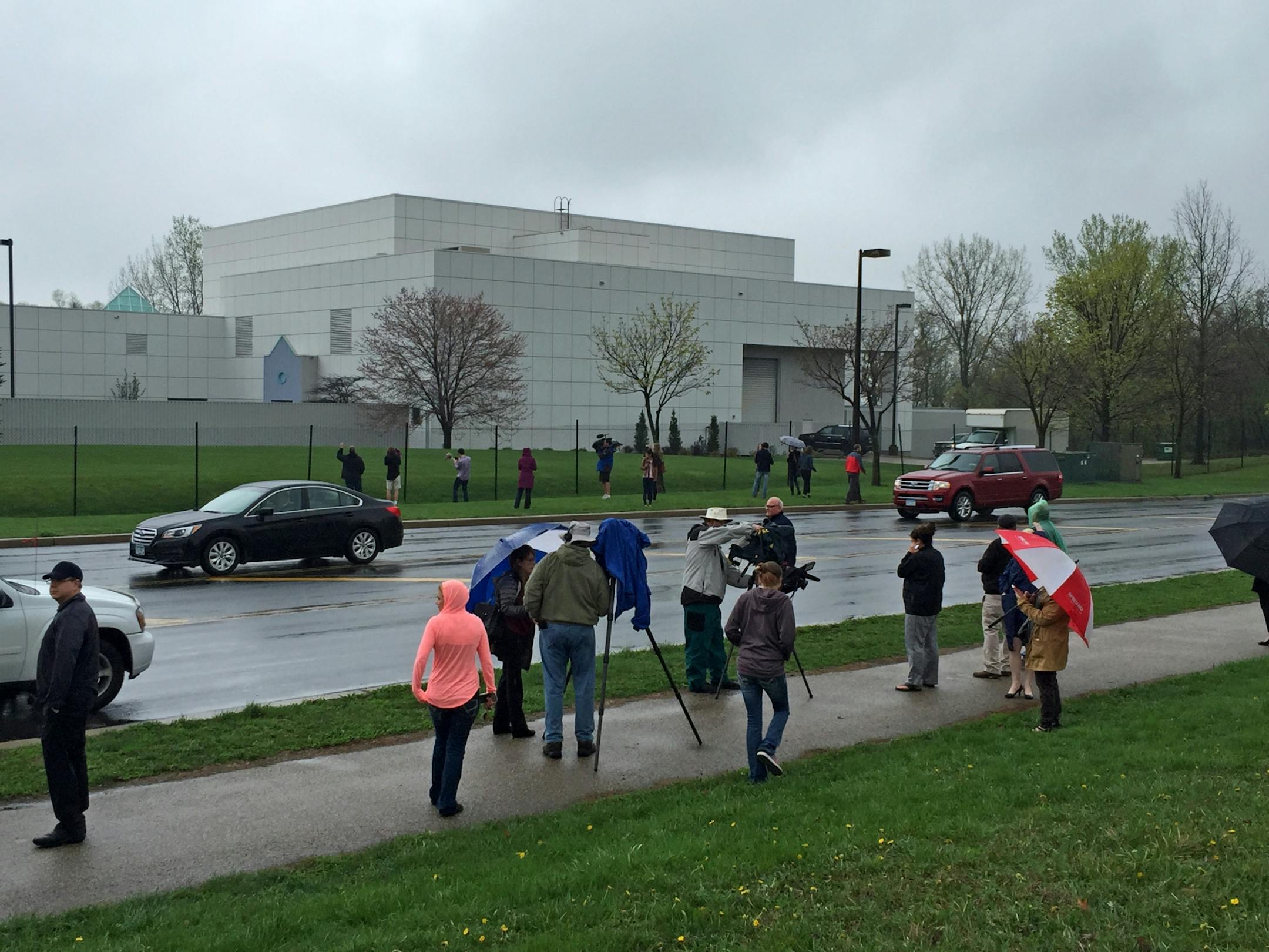 People and news media gather outside Paisley Park in Chanhassen, MN on the news of artist Prince death.