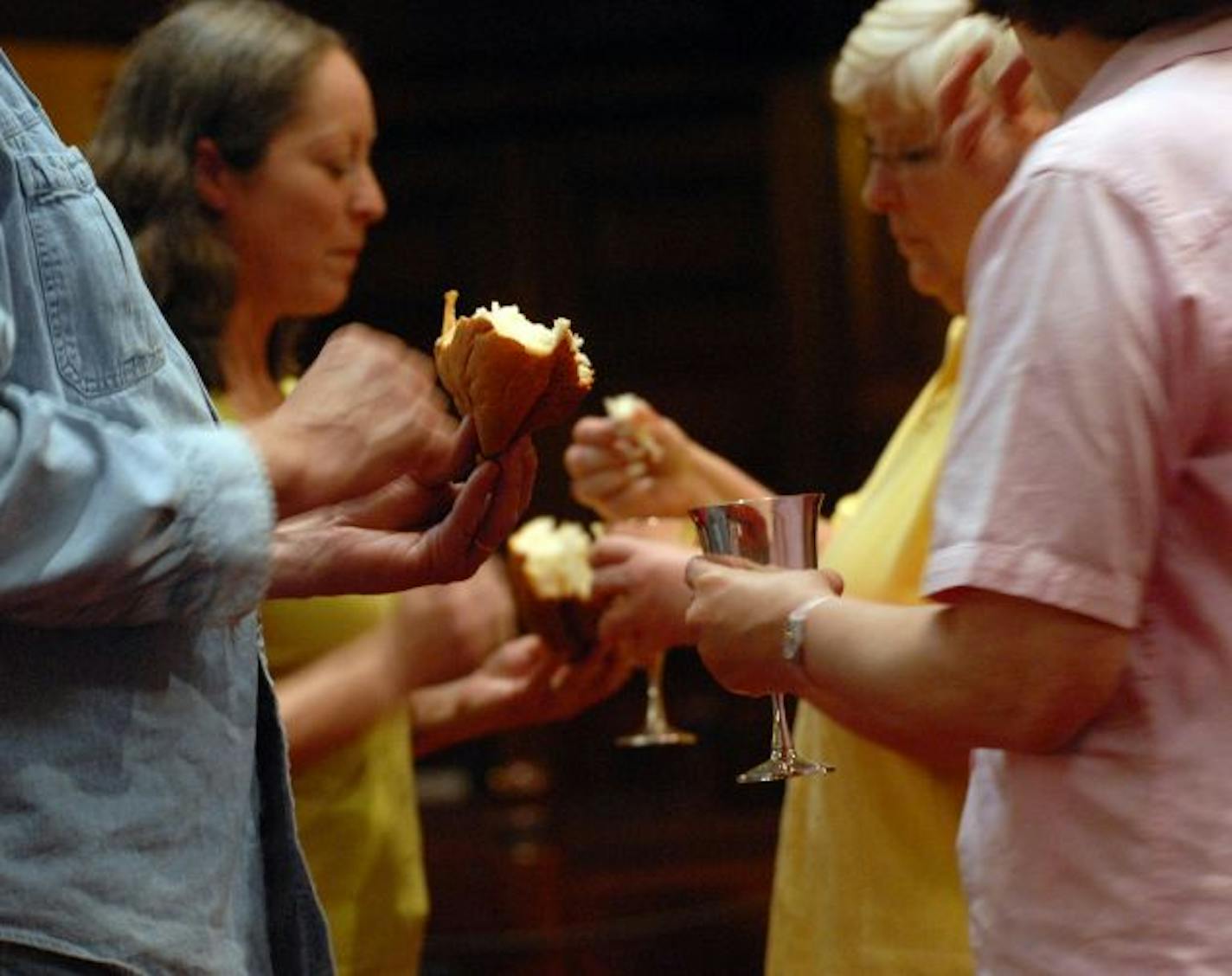 Communion servers take communion at the end of the service at Wesley United Methodist Church. Rev. Jo Campe was asked to hold a service with an AA theme. He started with one a month. Then two. Then they became so popular that he ended up with two every Sunday morning.