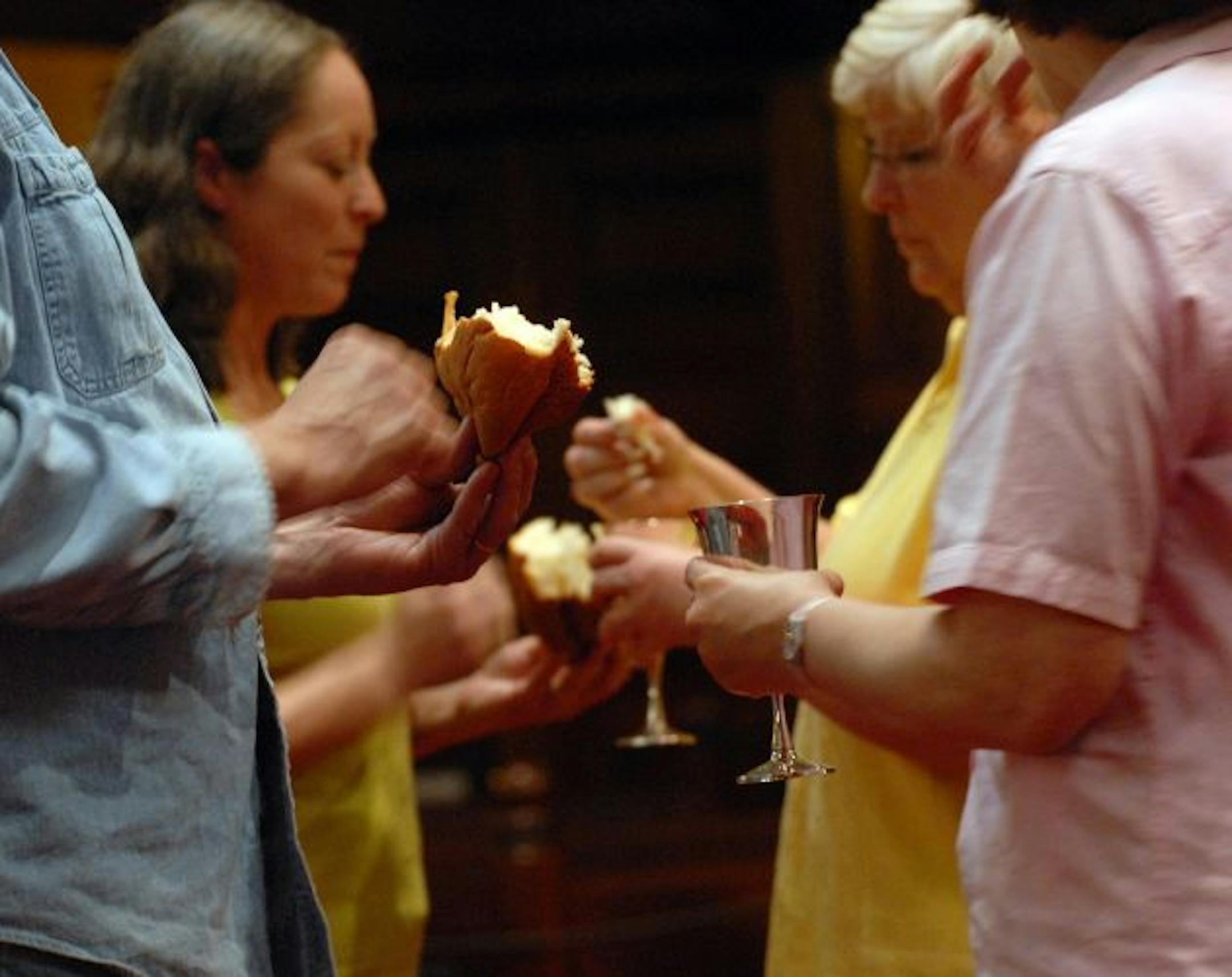 Communion servers take communion at the end of the service at Wesley United Methodist Church. Rev. Jo Campe was asked to hold a service with an AA theme. He started with one a month. Then two. Then they became so popular that he ended up with two every Sunday morning.