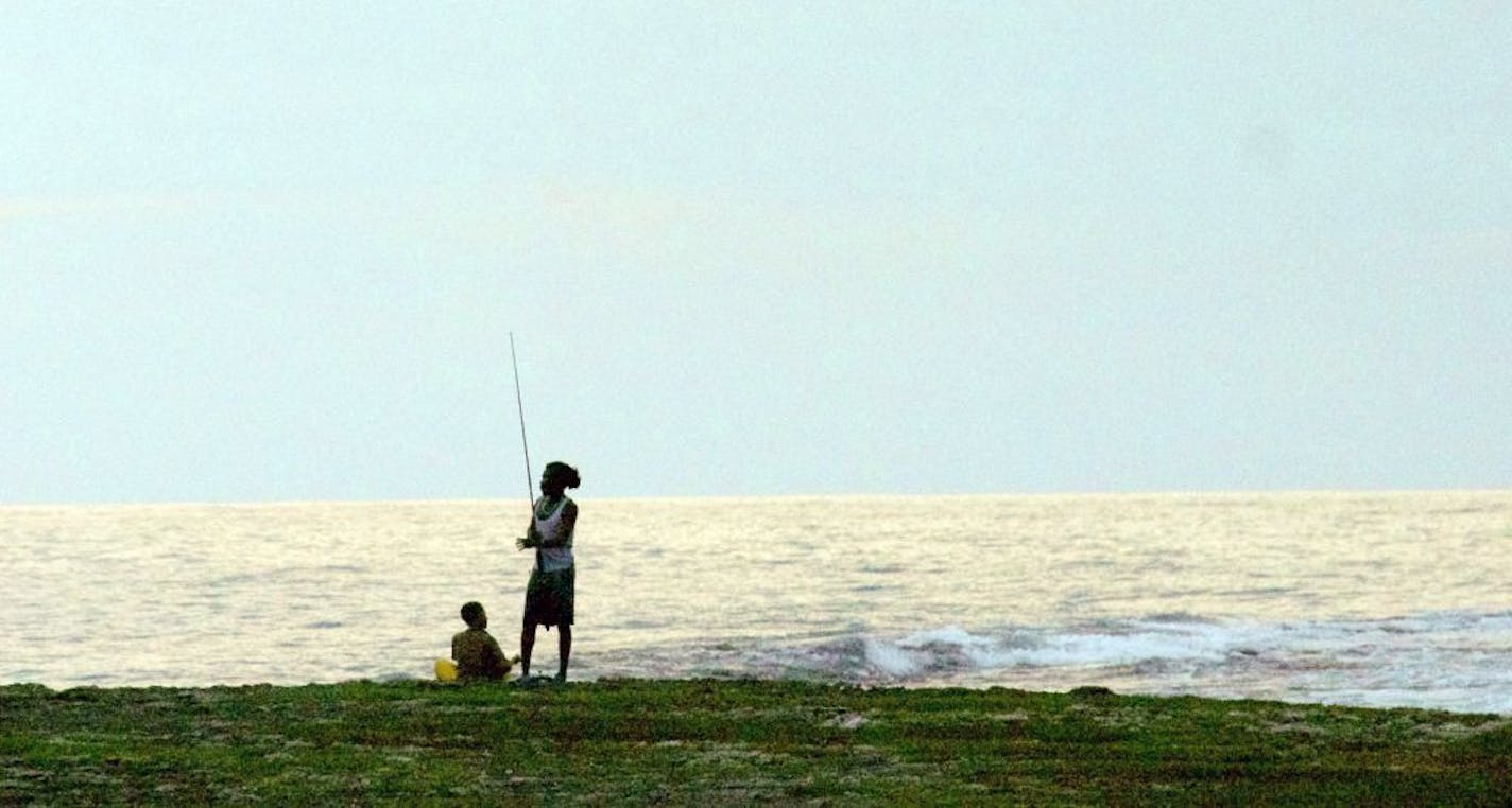 In the evening, the fishing poles come out on Jamaica's Treasure Beach.