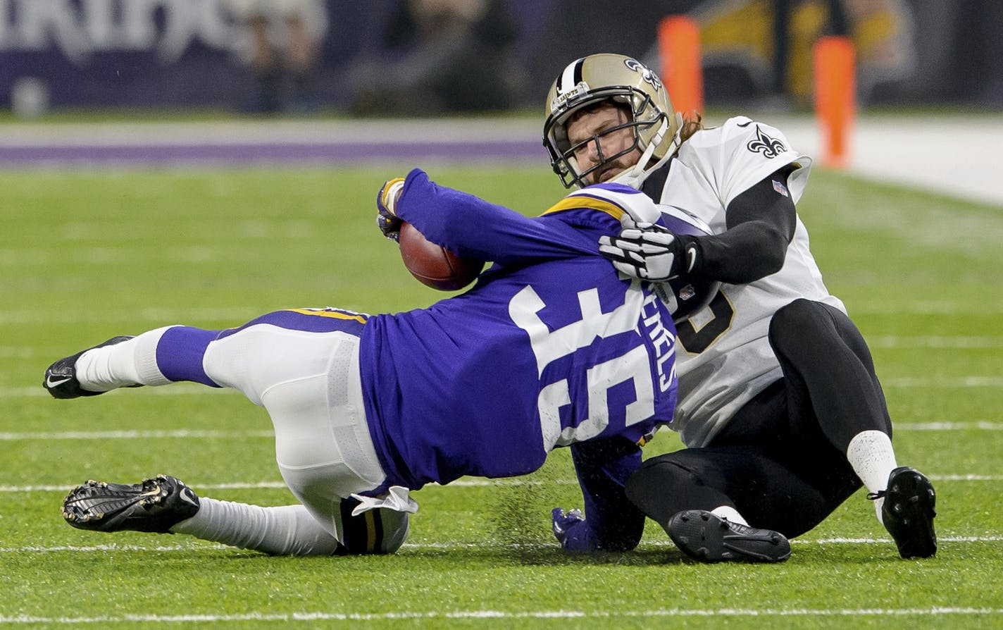 New Orleans Saints punter Thomas Morstead (6) injures his ribs on this touchdown saving tackle of Minnesota Vikings cornerback Marcus Sherels (35) in the first half of an NFC Divisional Playoff NFL football game in Minneapolis.