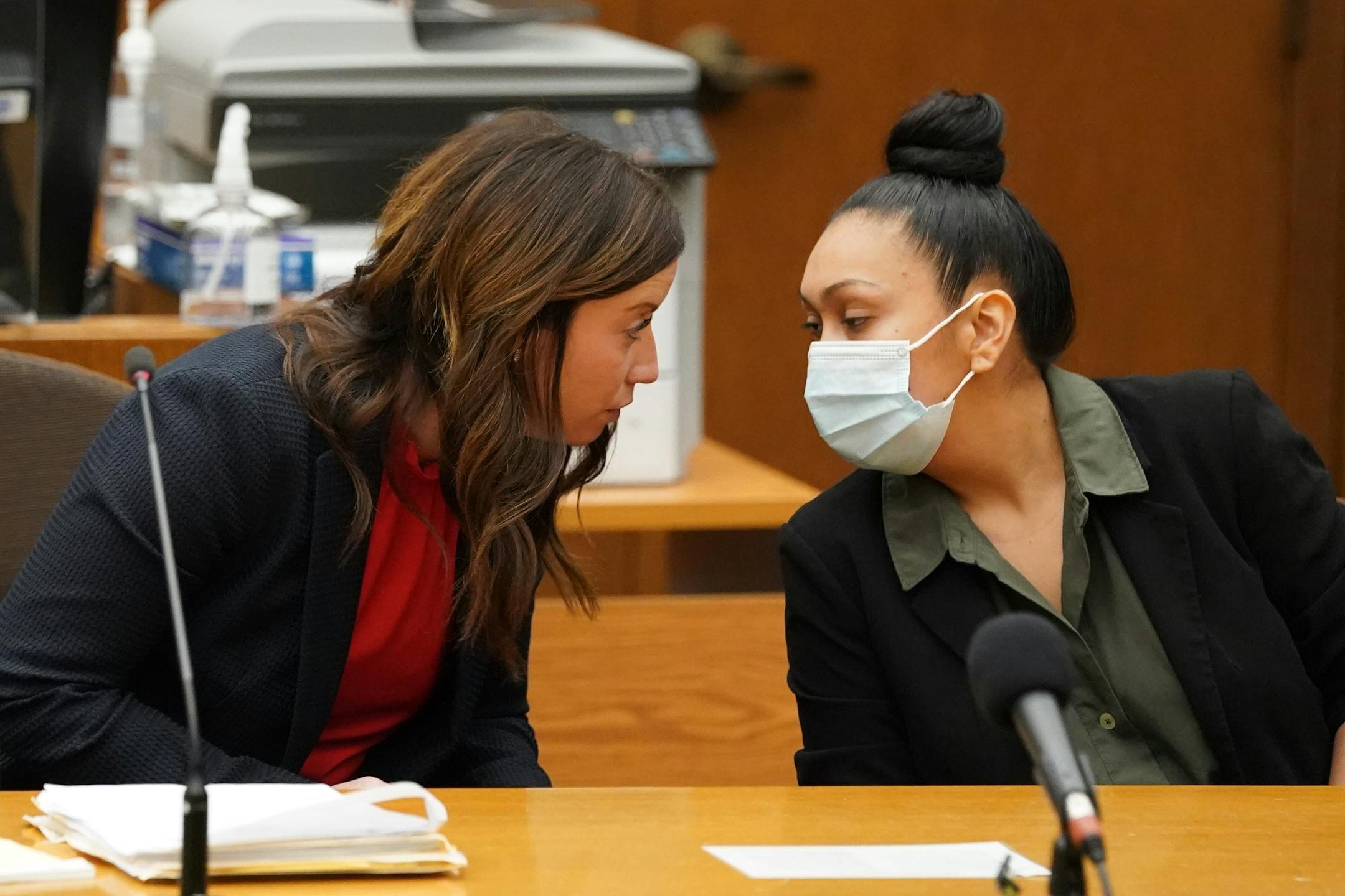 Defense attorney Amanda Montgomery, left, conferred with Elsa Segura before answering "no" when Judge Peter Cahill asked if she wanted to make a statement before her sentencing. Former Hennepin County probation officer, Elsa Segura, is sentenced, Tuesday, Nov. 9, 2021, in Hennepin County Court, Minneapolis, Minn., for luring Realtor, Monique Baugh, to a fake home showing where she was kidnapped and murdered.