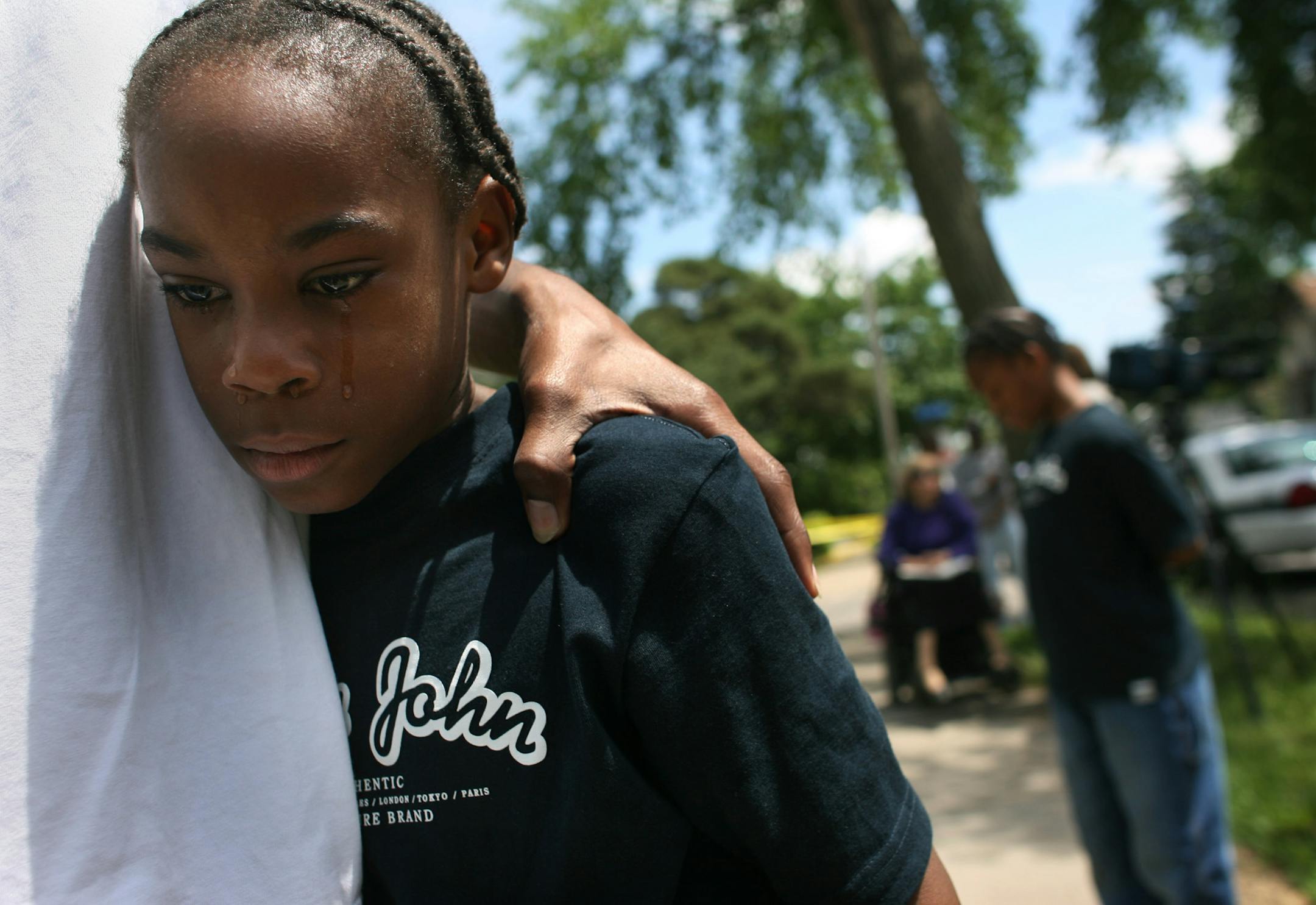 Deondre Hirocho, 17, held his younger brother, Kevon, 8, in his arm Thursday in south Minneapolis while he tried to comfort his 11-year-old brother, Wayne Veasey. One of the victims in the double homicide, Robert Shepard, 10, was Wayne's best friend. "It hurts," said Wayne.