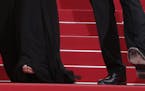 Julia Roberts paused as she ascended the red carpet steps at the Cannes Film Festival to show off her footwear -- or lack thereof. The shoes belong to