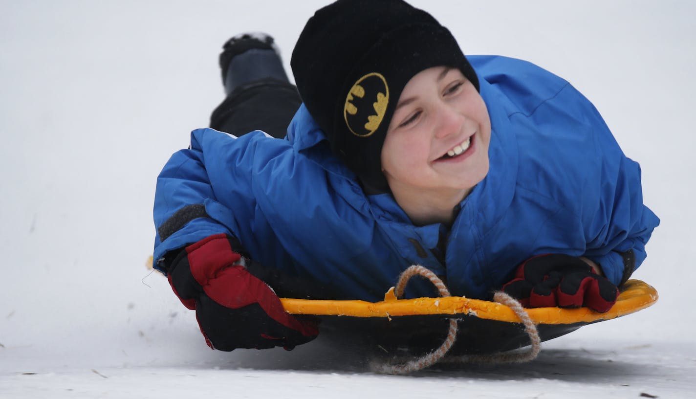 At the sledding hill at French Regional Park, Dolan Daniels,9, showed off his aerodynamic form.] rtsong-taatarii@startribune.com/ Richard Tsong-Taatarii