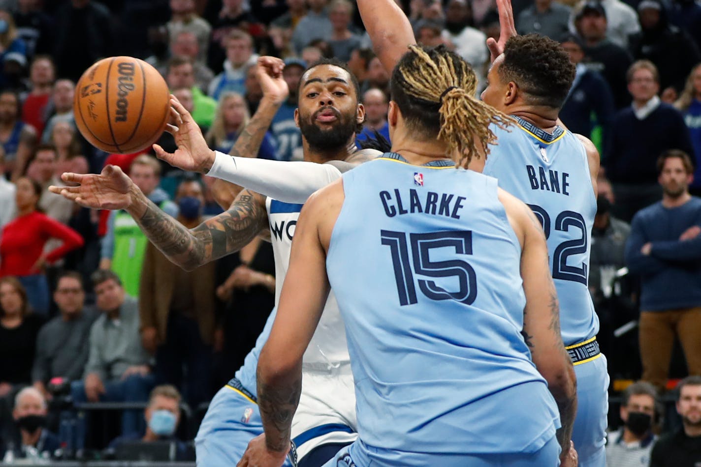 Timberwolves guard D'Angelo Russell passed the ball away from the defense of Memphis forward Brandon Clarke (15) and guard Desmond Bane. Russell scored 37 points in the Wolves' 119-114 victory at Target Center.